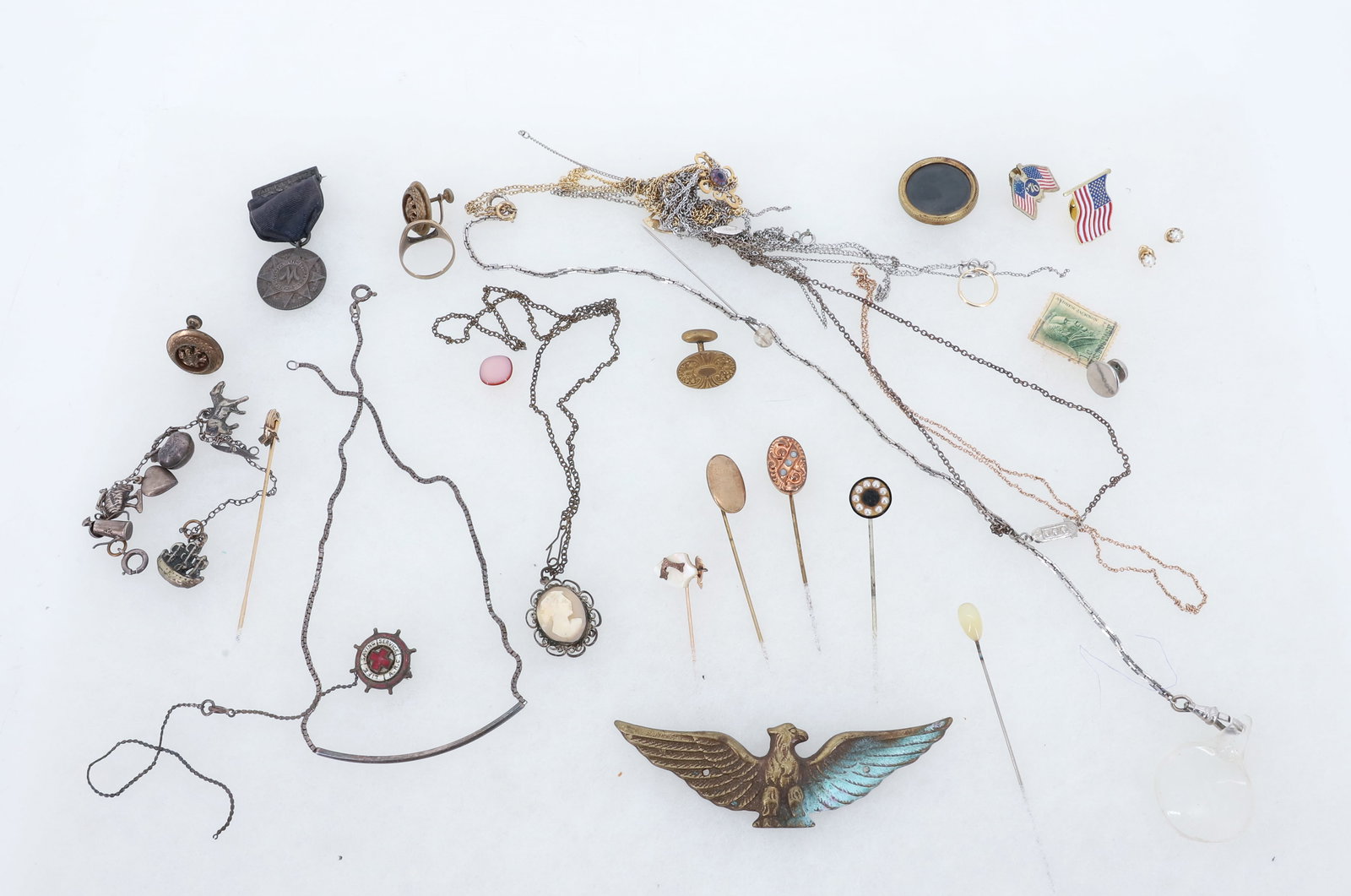 VICTORIAN JEWELRY LOT: STERLING SILVER CHARM BRACELET AND NECKLACE, INSURANCE MEDAL, CAMEO WITH METAL NECKLACE, FOUR STICK PINS, BRASS EAGLE AND GROUP OF TANGLED CHAINS ETC PLEASE READ CAREFULLY - Terms for Purchasing and S