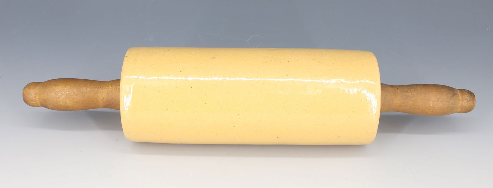 ANTIQUE YELLOW WARE ROLLING PIN: WOODEN HANDLES 15" X 3 1/4" PLEASE READ CAREFULLY - Terms for Purchasing and Shipping of Auction Items. Please read carefully before bidding. All payments for purchases will be made through LiveAuctio