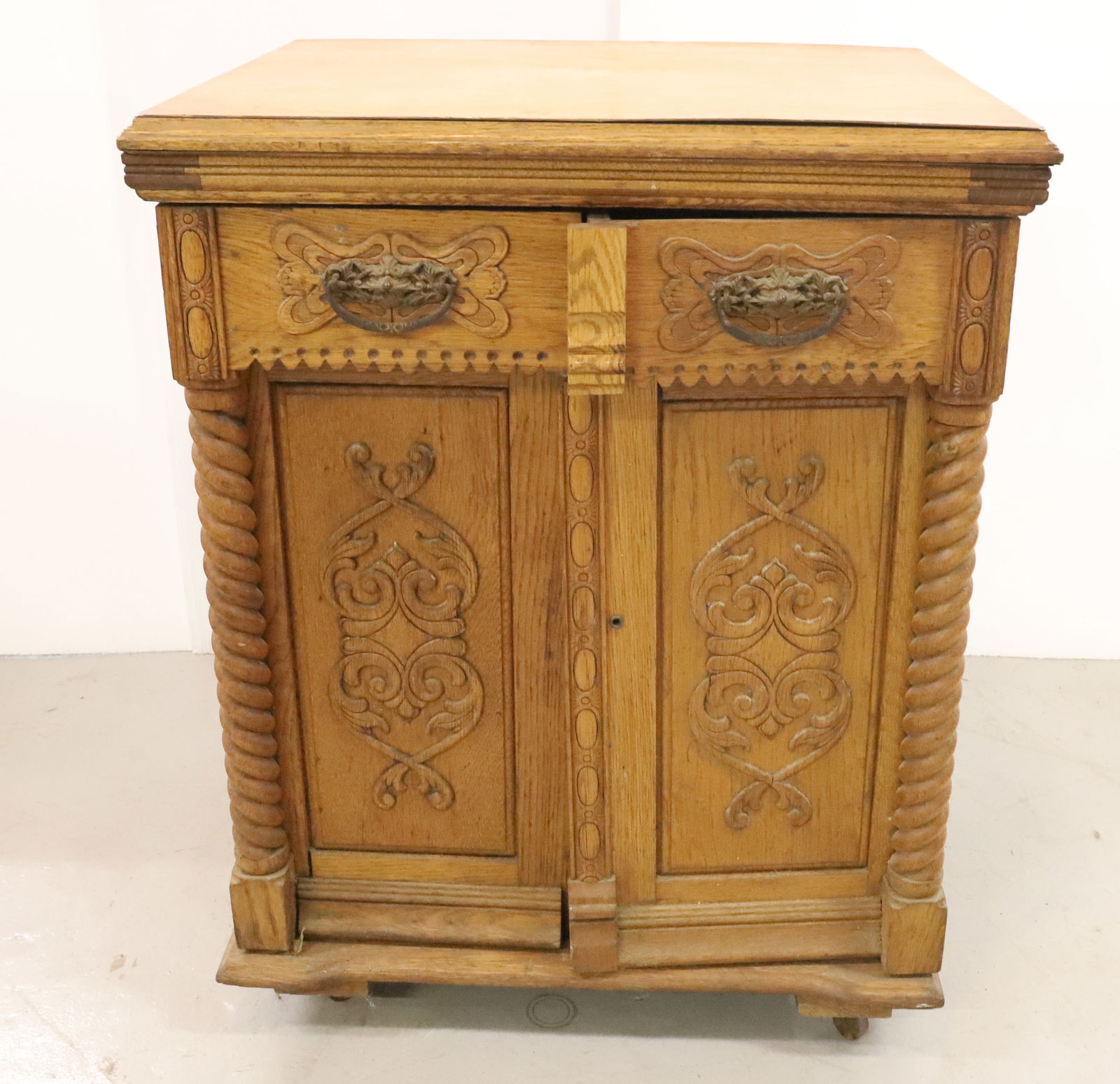 VICTORIAN OAK SEWING CABINET: HINGED LIFT LID WITH TWO SWING OUT DOORS WITH SWING OUT COMPARTMENTS, TWO DRAWERS INSIDE LOWER LEFT. ORNATE OAK CASE DOG FACE BRASS PULLS 32"H X 25 1/4" X 20 1/2" PLEASE READ CAREFULLY - Terms for Pur