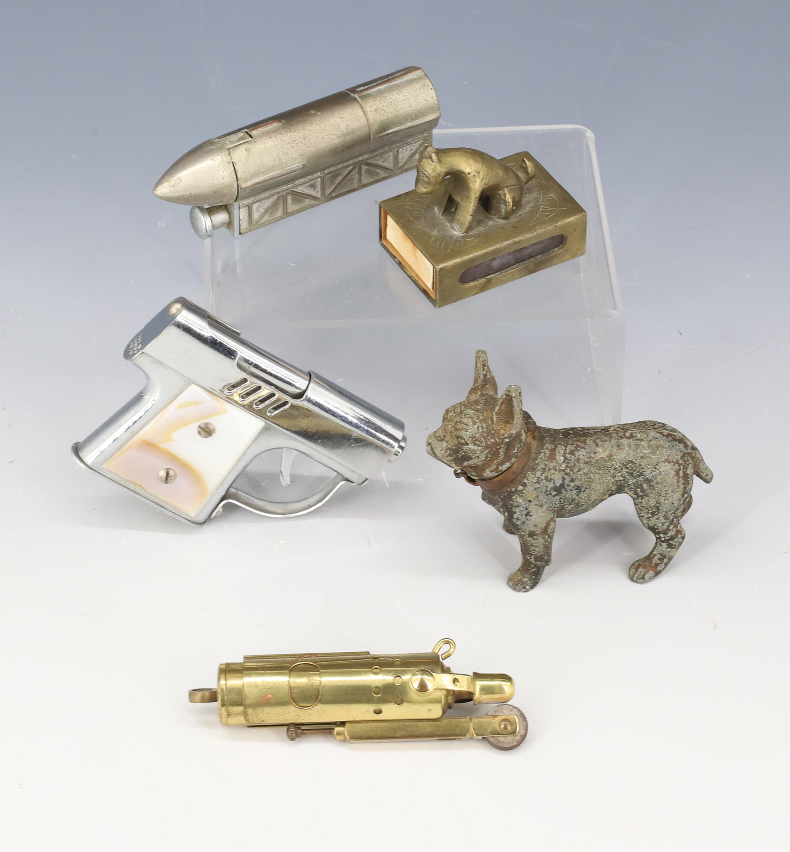 LOT OF NOVELTY LIGHTERS: INCLUDING: ROCKET SHIP 3 1/8" L., PAINTED CAST METAL DOG 2 3/4" L., BRASS DOG MATCHBOX HOLDER (CHINA), MINI PISTOL LIGHTER (OCCUPIED JAPAN) AND MORE. Terms: PLEASE READ CAREFULLY - Terms for Purchasin