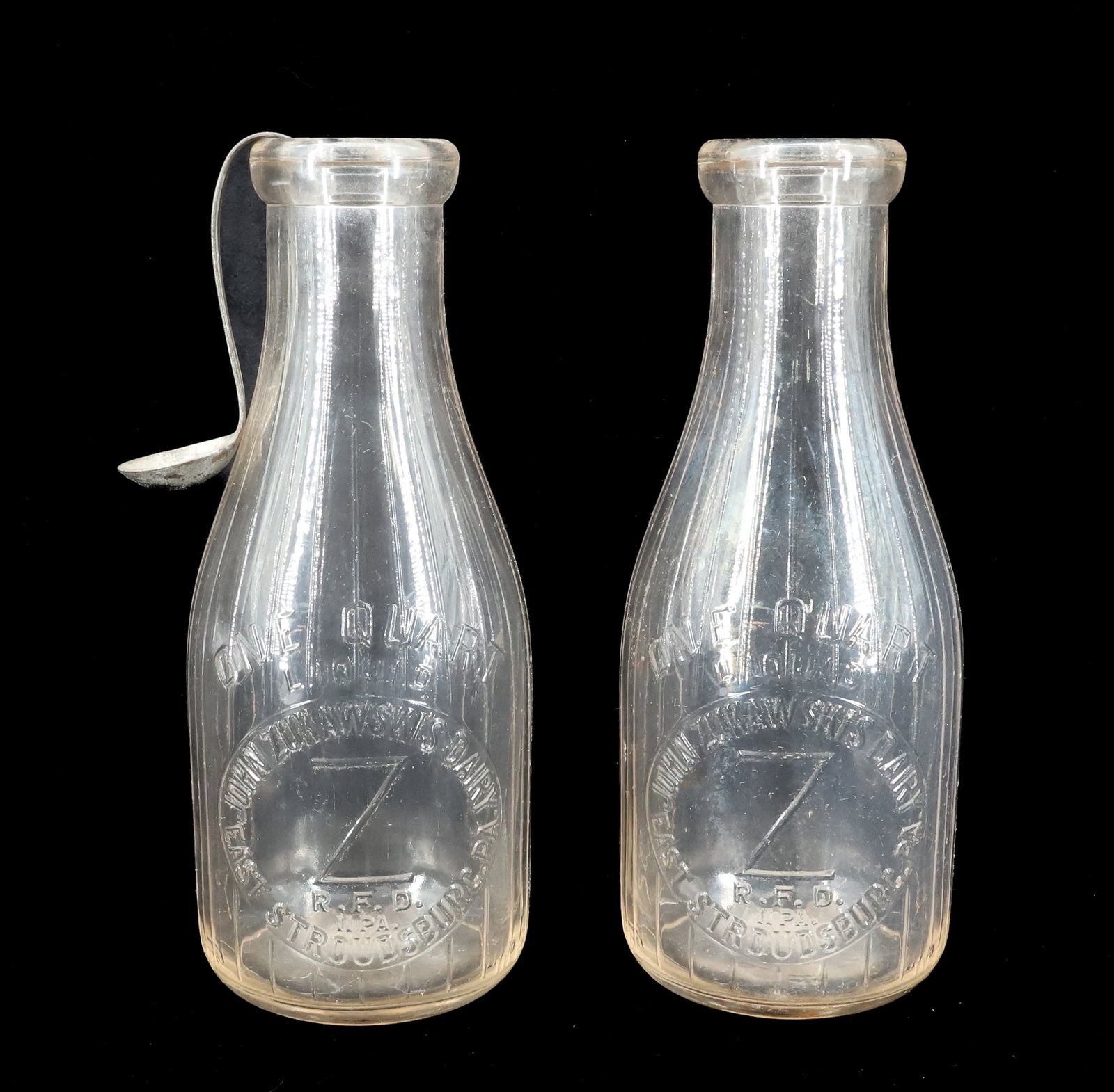 (2) EAST STROUDSBURG MILK BOTTLES: JOHN ZUKAWSKIS DAIRY QUART BOTTLES. CREAM TOP SPOON. 9 1/2" h. Terms: PLEASE READ CAREFULLY - Terms for Purchasing and Shipping of Auction Items. Please read carefully before bidding. All payments for