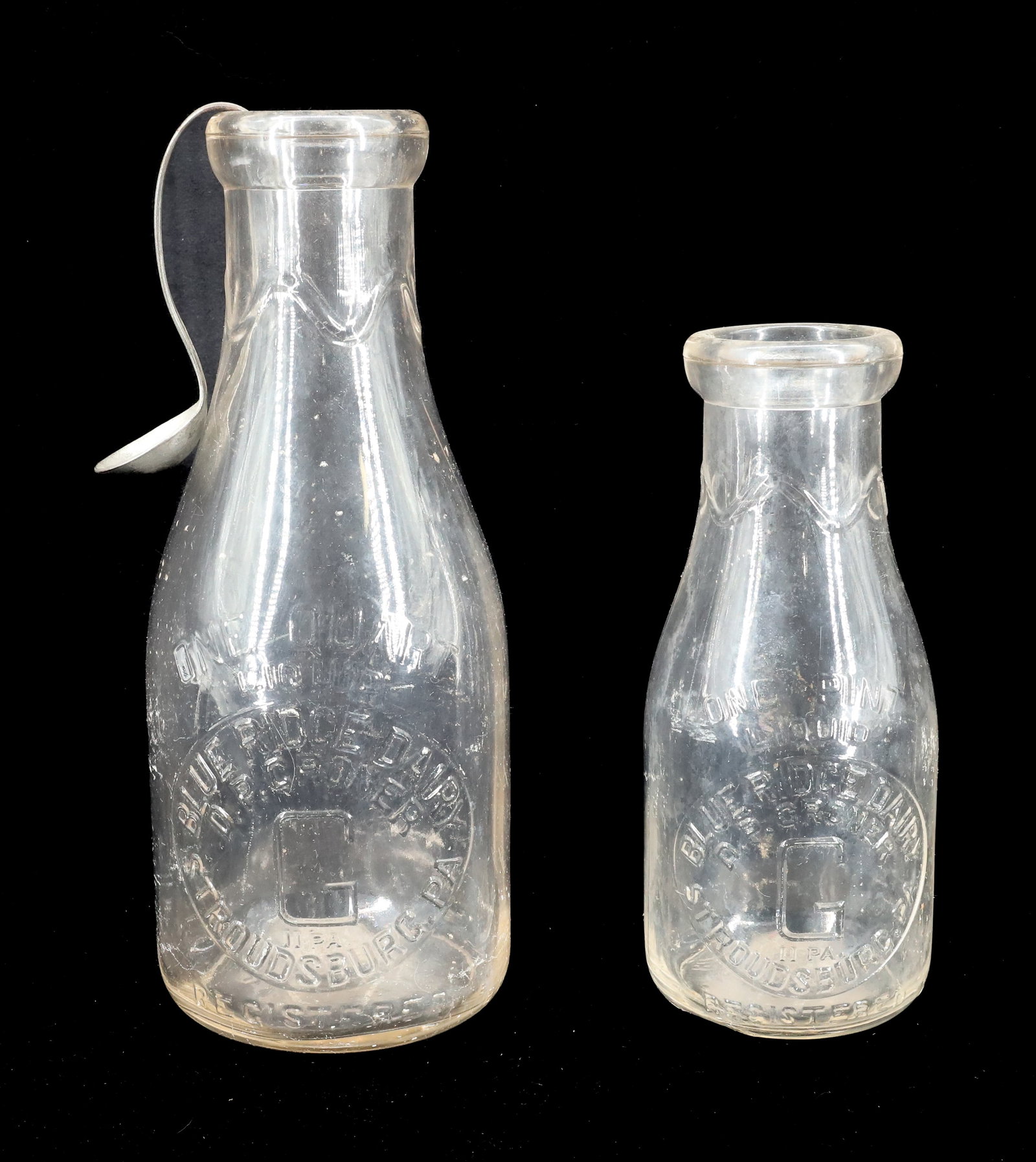 (2) STROUDSBURG, PA MILK BOTTLES: BLUE RIDGE DAIRY, D.P. GRONER. PINT, QUART AND CREAM TOP SPOON. 7 1/4" TO 9 1/2". Terms: PLEASE READ CAREFULLY - Terms for Purchasing and Shipping of Auction Items. Please read carefully before biddin