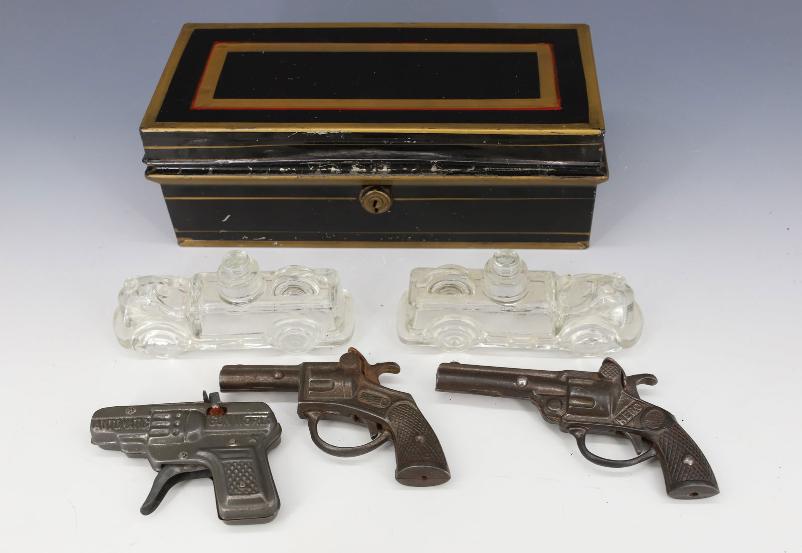 CAP GUNS, CANDY CONTAINERS AND CASH BOX: TWO CAST IRON CAP GUNS (ECHO AND HERO) AND ONE METAL. TWO GLASS FIRE ENGINE CANDY CONTAINERS 4 3/4" L. AND PAINTED CASH BOX 9" L. PLEASE READ CAREFULLY - Terms for Purchasing and Shipping of Auction I