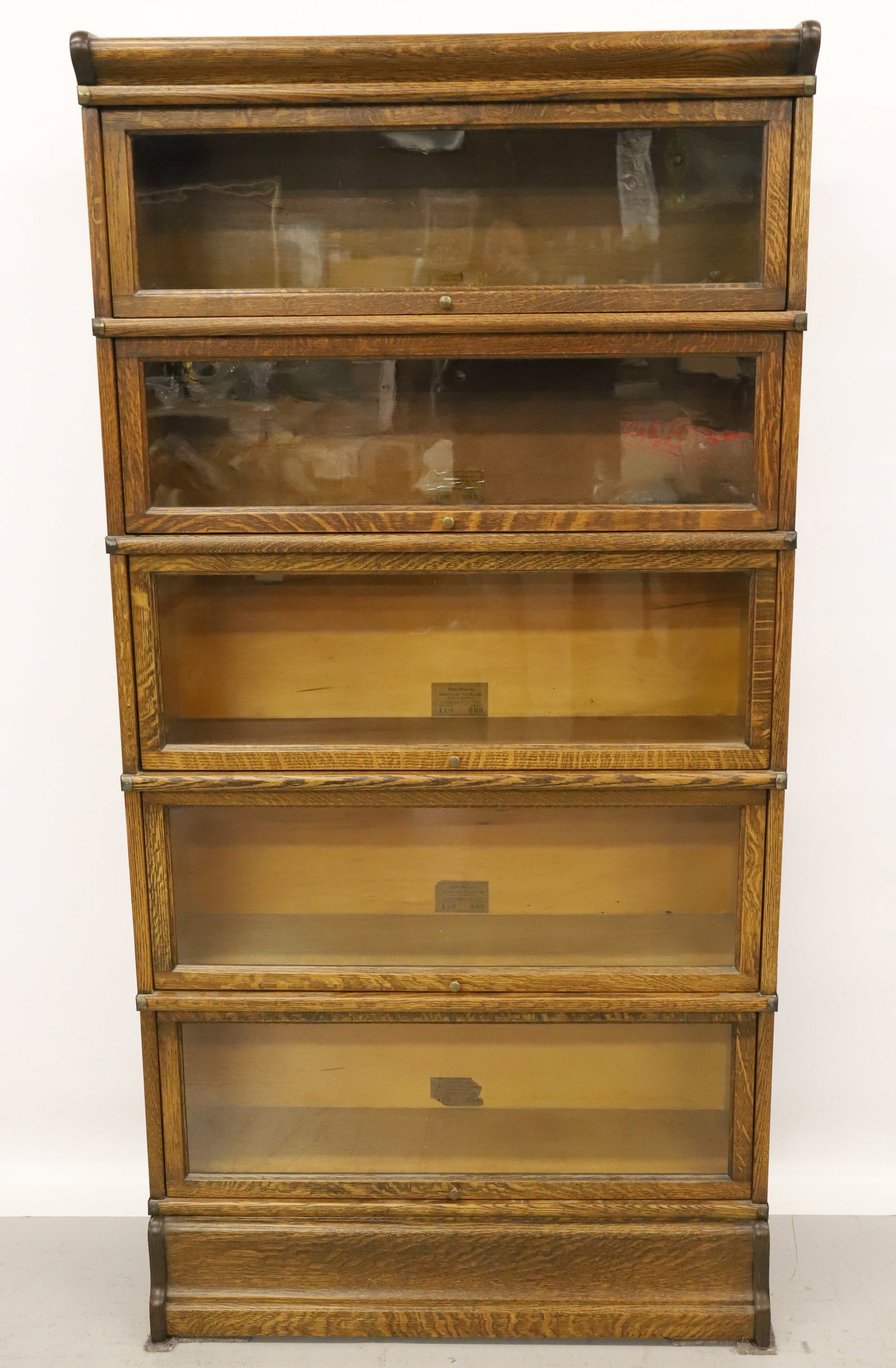GLOBE-WERNICKE STACKING BOOKCASE: FIVE-SECTION OAK BOOKCASE. LABELED SECTIONS "STANDARD D 8 1/2 AND D 10 1/4" SECTIONS. 68" X 34" X 11 1/2". PLEASE READ CAREFULLY - Terms for Purchasing and Shipping of Auction Items. Please read caref