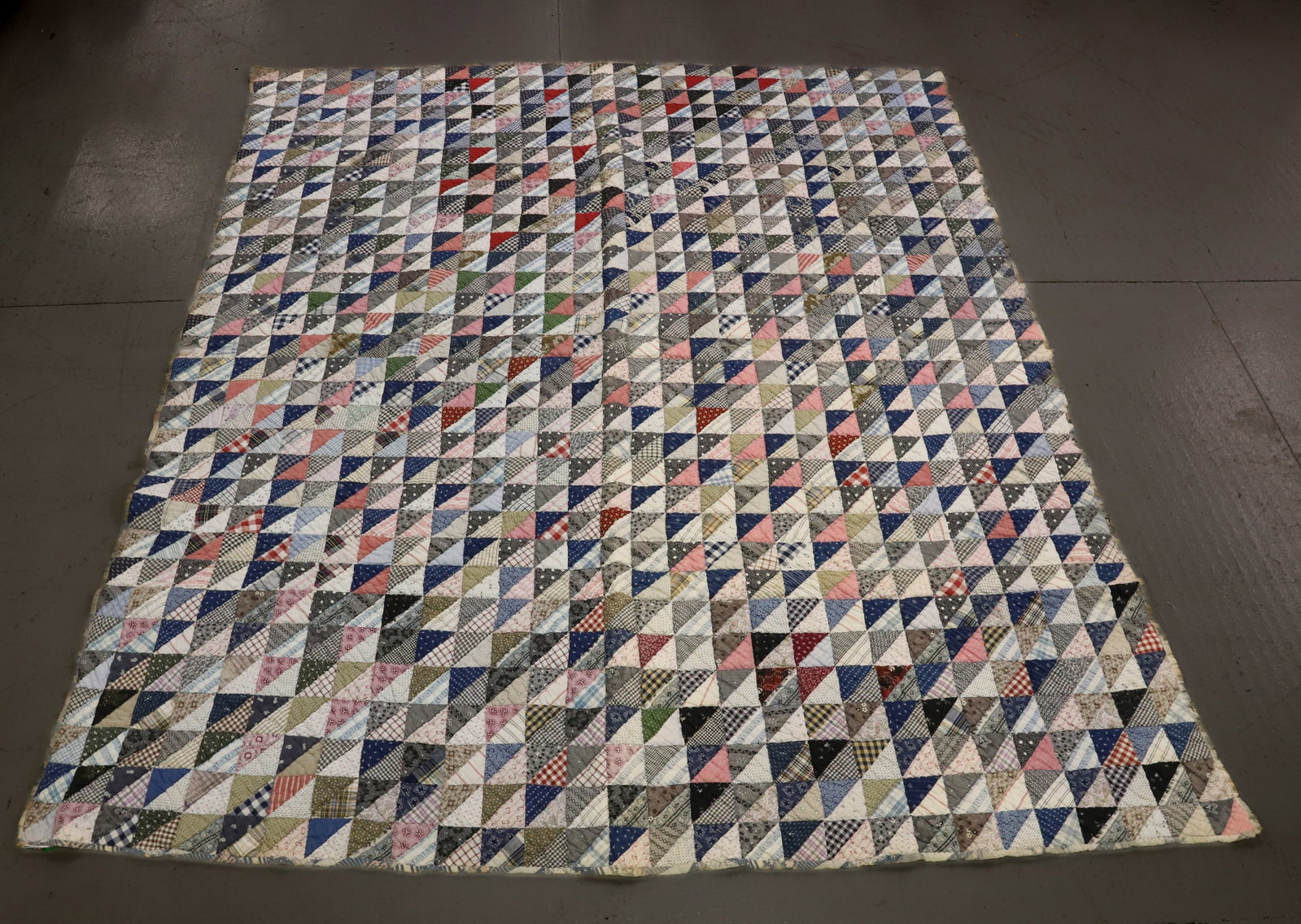 VINTAGE HAND STITCHED QUILT: SMALL SQUARE/TRIANGLE PATTERN WITH BLUE/PINK BACKING. 75" X 64". PLEASE READ CAREFULLY - Terms for Purchasing and Shipping of Auction Items. Please read carefully before bidding. All payments for purc