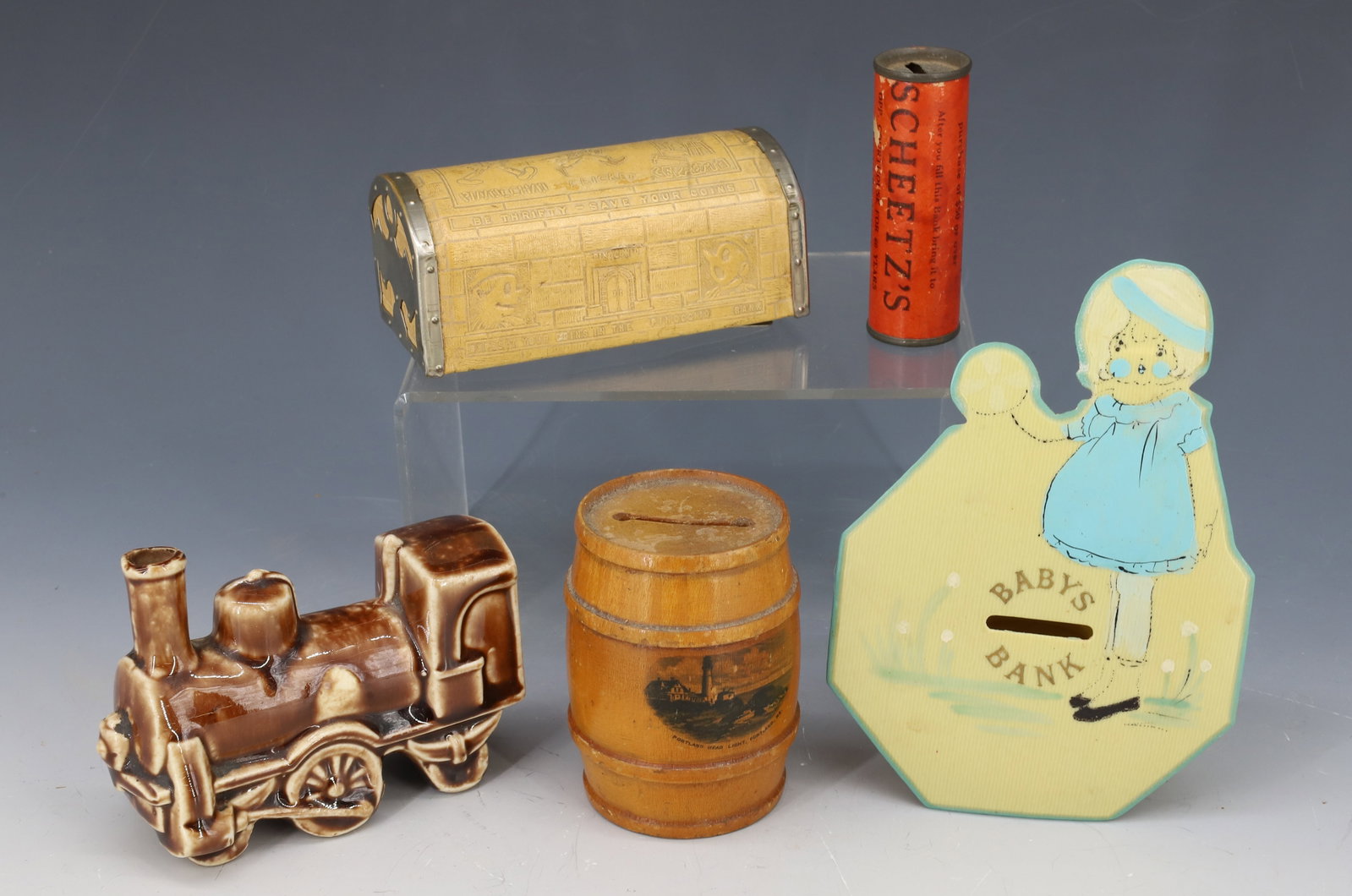 LOT OF (5) NOVELTY BANKS: INCLUDING; BABYS BANK, WOODEN BARREL "PORTLAND, ME", CERAMIC LOCOMOTIVE "AUSTRIA", PINOCCHIO BANK (4 1/4" L), AND SCHEETZS ADV. BANK PLEASE READ CAREFULLY - Terms for Purchasing and Shipping of Auctio