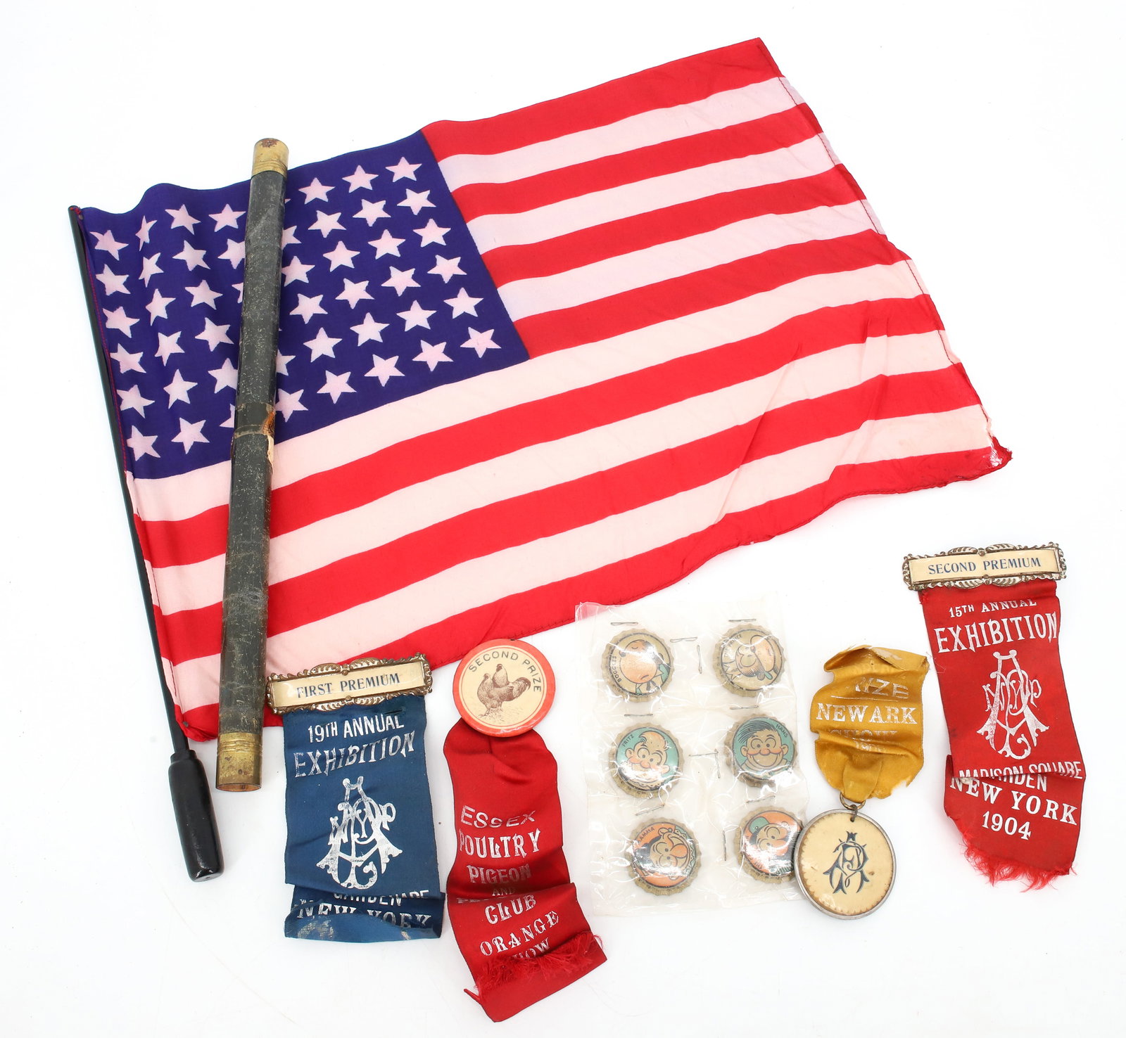 KATZENJAMMER KIDS CAPS, RIBBONS AND FLAG: SIX CHARACTER BOTTLE CAPS, EARLY 20TH C. NY RIBBONS AND SILK FLAG IN CONTAINER. PLEASE READ CAREFULLY - Terms for Purchasing and Shipping of Auction Items. Please read carefully before bidding. All pa