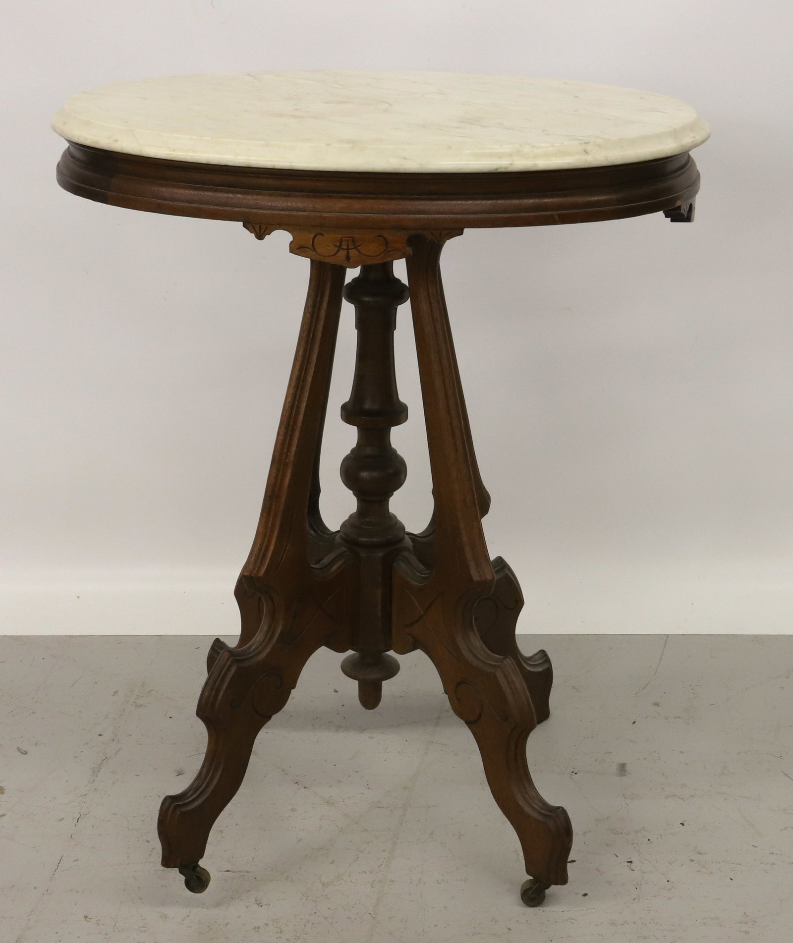 VICTORIAN MARBLE TOP TABLE: MARBLE TOP, WALNUT BASE WITH INCISED DESIGN - 30" X 24" X 18" PLEASE READ CAREFULLY - Terms for Purchasing and Shipping of Auction Items. Please read carefully before bidding. All payments for purchas