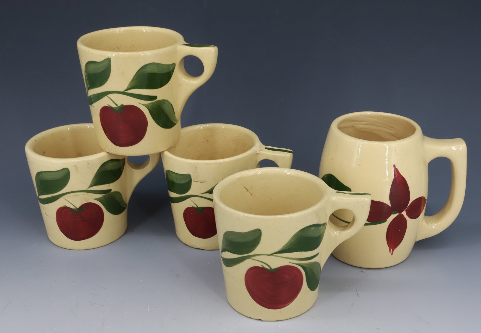 (5) WATT WARE MUGS: (4) APPLE MUGS 3 3/4" AND STAR FLOWER MUG 4 3/4" PLEASE READ CAREFULLY - Terms for Purchasing and Shipping of Auction Items. Please read carefully before bidding. All payments for purchases will be ma