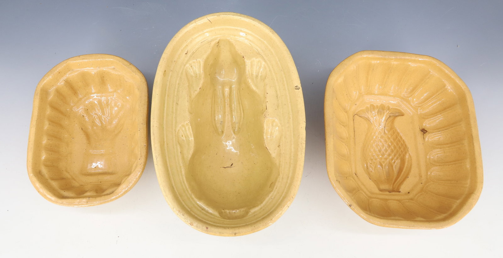 (3) YELLOW WARE FOOD MOLDS: INCLUDING; WHEAT, PINEAPPLE, AND RABBIT - RABBIT 8 1/2" L PLEASE READ CAREFULLY - Terms for Purchasing and Shipping of Auction Items. Please read carefully before bidding. All payments for purchases w
