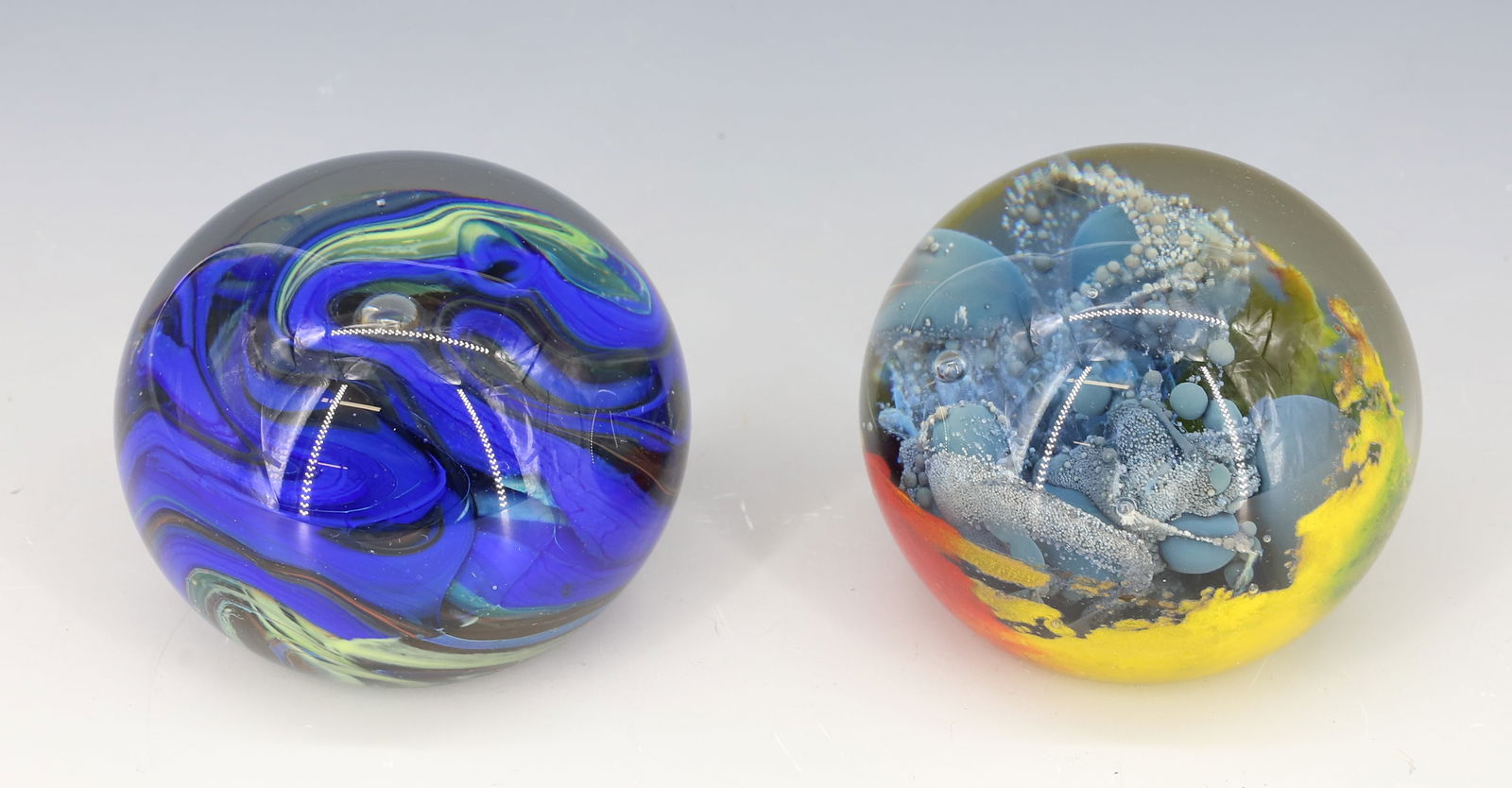 (2) SIGNED ART GLASS PAPERWEIGHTS: MILROPA CLOUD OF BLUE OPAQUE BUBBLES 1978 AND BLUE WITH CONTROLLED BUBBLE BOTH SIGNED 2 1/2"H PLEASE READ CAREFULLY - Terms for Purchasing and Shipping of Auction Items. Please read carefully before b