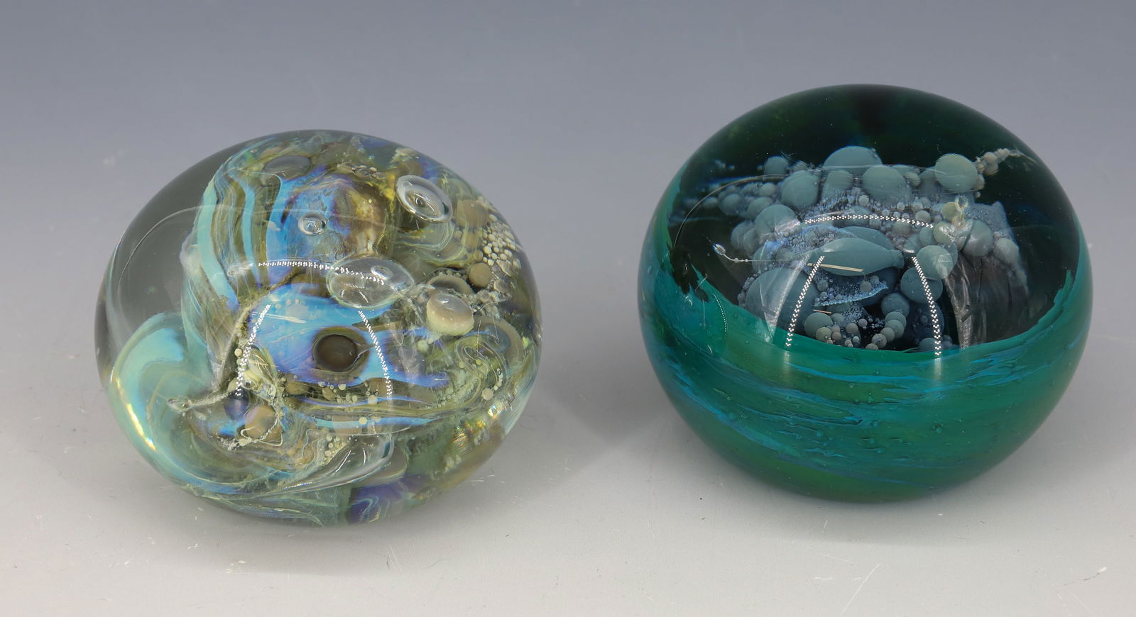 (2) SIGNED ART GLASS PAPERWEIGHTS: MILROPA BLUE CLOUD OF BUBBLES AND TURQUOISE GREEN BASE, LIGHT BLUE OPAQUE AND CLEAR BUBBLES SIGNED MILROPA AND ARTIST 2 1/4"H, 3"H PLEASE READ CAREFULLY - Terms for Purchasing and Shipping of Auction