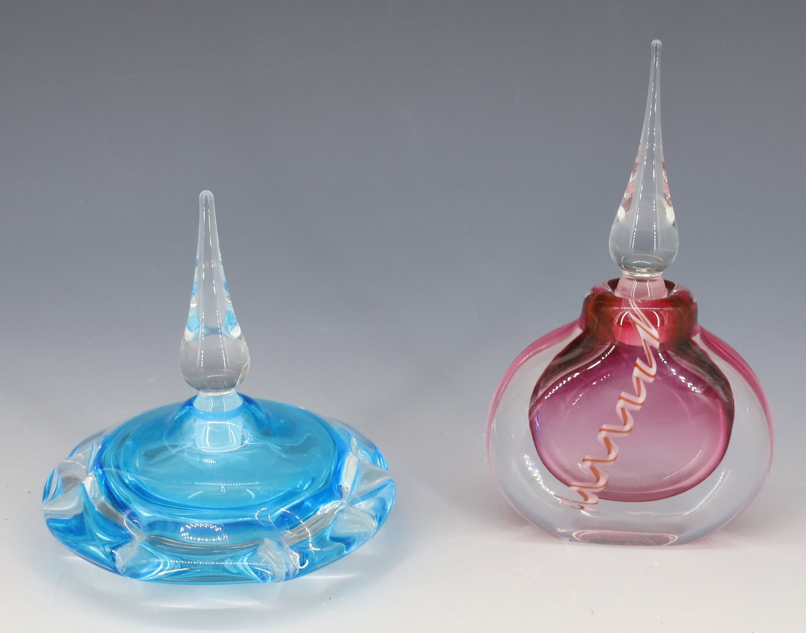 (2) VANDERMARK PERFUME BOTTLES: CRANBERRY WITH SWIRLED CAINE AND SQUAT SHAPE LIGHT BLUE BOTH HAVE STEEPLE STOPPERS 5"H,6" PLEASE READ CAREFULLY - Terms for Purchasing and Shipping of Auction Items. Please read carefully before biddi