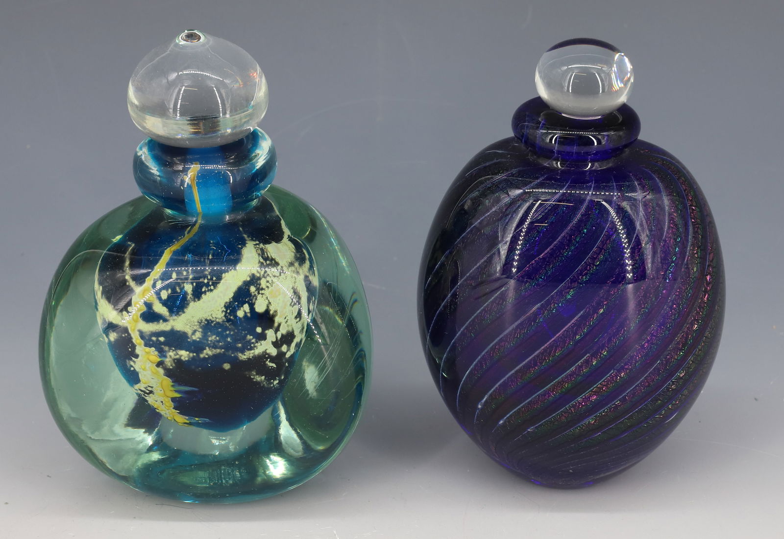 (2) SIGNED ART GLASS PERFUME BOTTLES: ART GLASS PERFUMERS, PURPLE AND BLUE, SIGNED ON BOTTOM, 5 1/4" AND 5" - HEAVY GLASS PERFUMERS PLEASE READ CAREFULLY - Terms for Purchasing and Shipping of Auction Items. Please read carefully before b