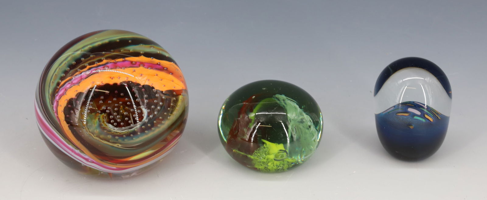 (3) ART GLASS PAPERWEIGHTS: MULTI COLOR SWIRL WITH CONTROLLED BUBBLES SIGNED SEIDE, BLUE OPAQUE BASE WITH GREEN , YELLOW AND WHITE SIGNED R.S. 1987 AND SOUTH JERSEY WITH GREENISH GLASS AND THREE FLOWERS ROUGH GROUND BASE 1 3/4"H