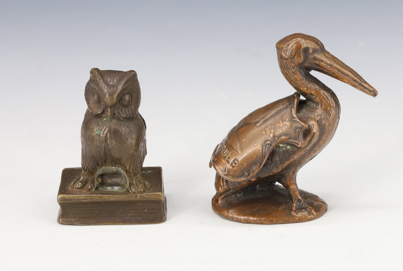 (2) BRONZE MINIATURE FIGURES: OWL ON BOOK (MRKD. FINE) 1 1/2" H. AND SOUVENIR PELICAN BRONZE "PASS-A-GRILLE" 2" H. PLEASE READ CAREFULLY - Terms for Purchasing and Shipping of Auction Items. Please read carefully before bidding. A