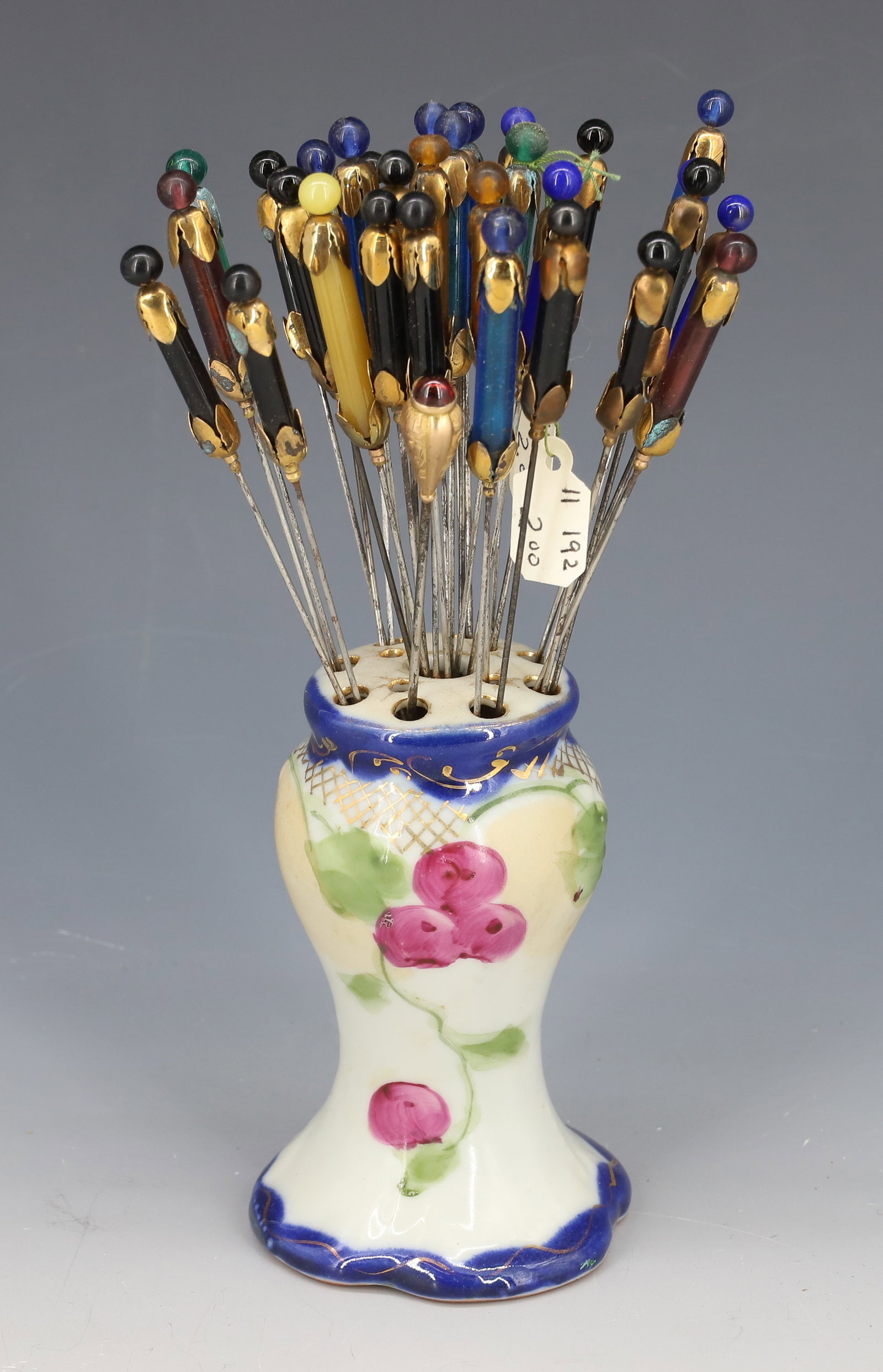 (33) HATPINS AND HOLDER: 10K GOLD WITH GARNET STONE, (30+) GLASS BEADS AND BRASS 7" PLEASE READ CAREFULLY - Terms for Purchasing and Shipping of Auction Items. Please read carefully before bidding. All payments for purchases 