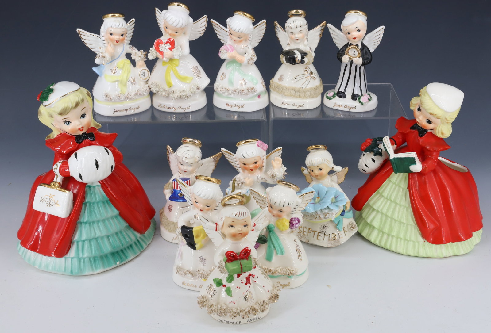 LOT OF CERAMIC ANGELS AND CAROLERS: (11) VARIOUS MONTH ANGELS (SOME MRKD. ON BOTTOM NAPCO) AVERAGE 4 1/2" H. TWO LARGE NAPCO CAROLER PLANTERS. LARGER 7 1/4" H. PLEASE READ CAREFULLY - Terms for Purchasing and Shipping of Auction Items. 