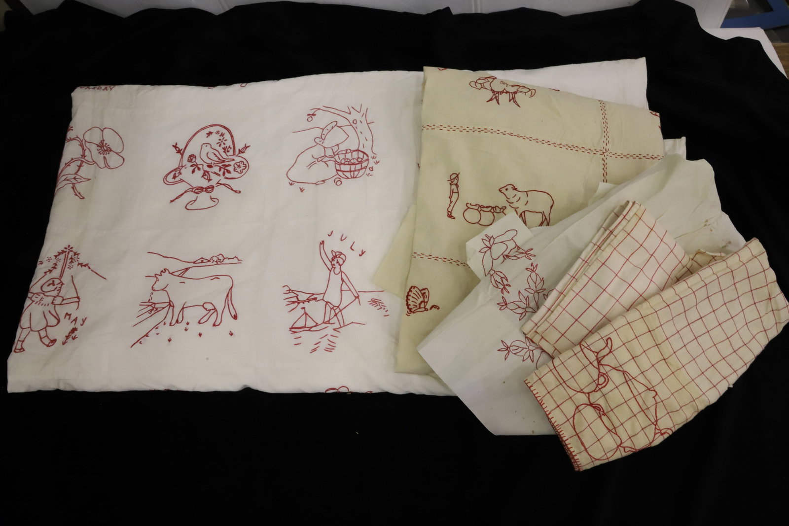 LOT OF RED AND WHITE TEXTILES: INCLUDING: TEA TOWELS, APRON, QUILT TOP (SCENES OF ANIMALS/CHILDREN), DUVET BED COVER WITH SUNBONNET GIRLS, FLOWERS, ANIMALS, KEWPIES AND MORE. PLEASE READ CAREFULLY - Terms for Purchasing and Shippin