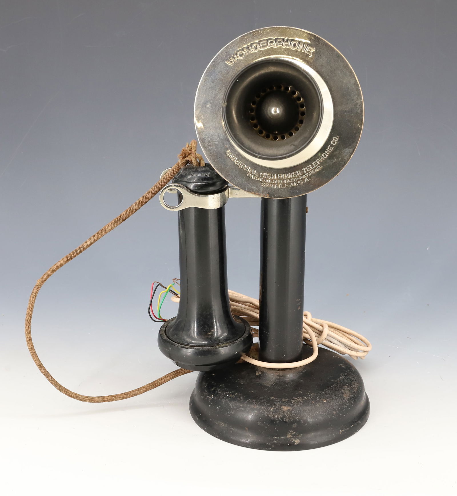 CANDLESTICK PHONE BY UNIVERSAL HIGH POWER: "WONDERPHONE" PAT. 1917, SEATTLE, USA. BLACK PAINTED METAL. 11 1/4" H. EARPIECE MRKD. STROMBERG CARLSON PLEASE READ CAREFULLY - Terms for Purchasing and Shipping of Auction Items. Please read carefull