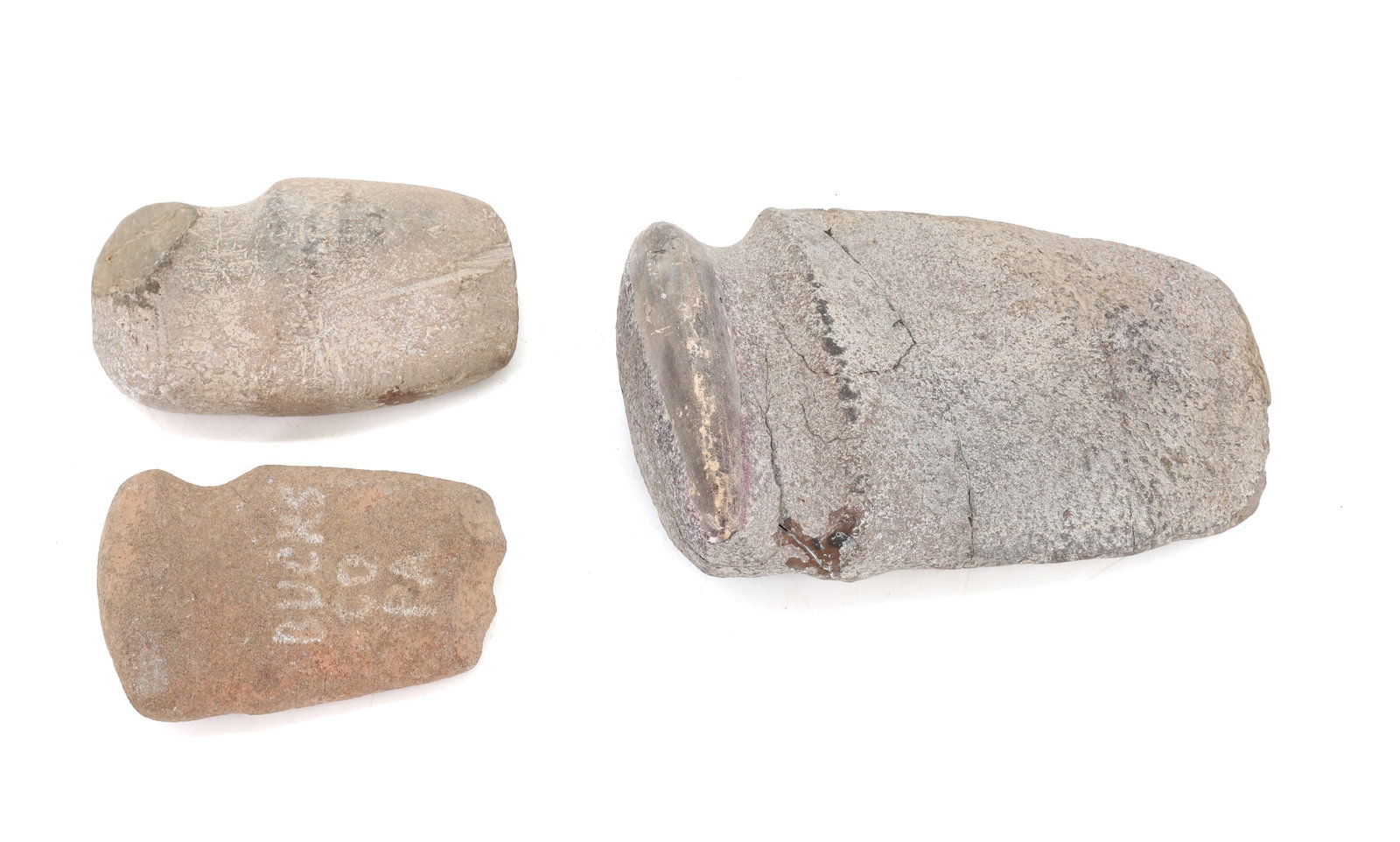 NATIVE AMERICAN AXE HEADS: (3) GROOVED AXE HEADS. SMALLEST MRKD. BUCKS CO. PA 3 3/4" L. LARGEST 6 1/4" L. PLEASE READ CAREFULLY BEFORE BIDDING. ALL PAYMENTS MUST BE MADE BEFORE ITEMS CAN BE SHIPPED. BUYERS CAN PAY VIA LIVE AUCT
