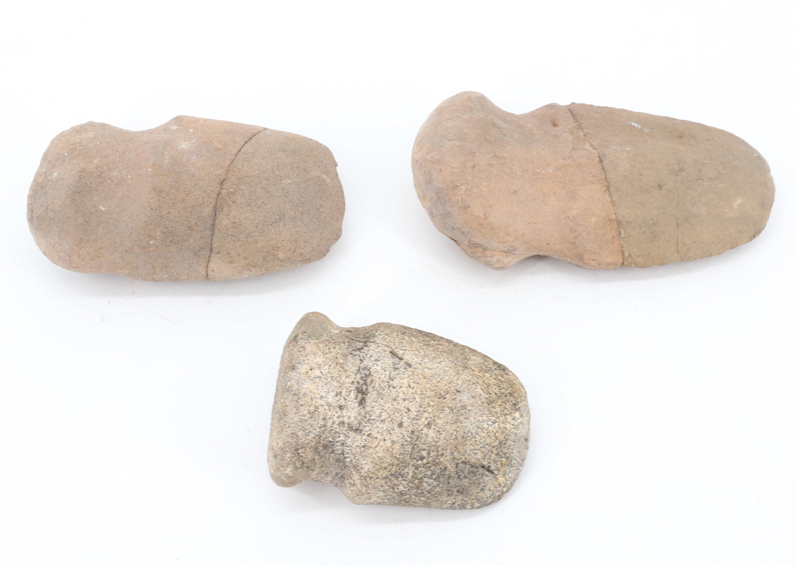 (3) STONE AXE HEADS: GROOVED AXE HEADS. 4" TO 6 1/4" LENGTHS. PLEASE READ CAREFULLY BEFORE BIDDING. ALL PAYMENTS MUST BE MADE BEFORE ITEMS CAN BE SHIPPED. BUYERS CAN PAY VIA LIVE AUCTIONEERS PAYMENT CENTER IF HAVING ITEMS