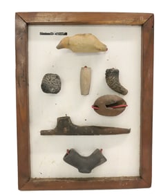 FRAMED COLLECTION OF POTTERY PIPES