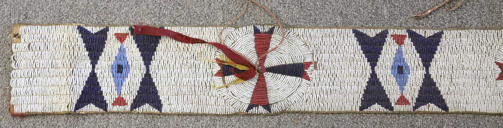 NATIVE AMERICAN BEADED BLANKET STRIP: SMALL COLORED GLASS BEADS SEWN ON HIDE. 4 1/4" X 72". PLEASE READ CAREFULLY BEFORE BIDDING. ALL PAYMENTS MUST BE MADE BEFORE ITEMS CAN BE SHIPPED. BUYERS CAN PAY VIA LIVE AUCTIONEERS PAYMENT CENTER IF