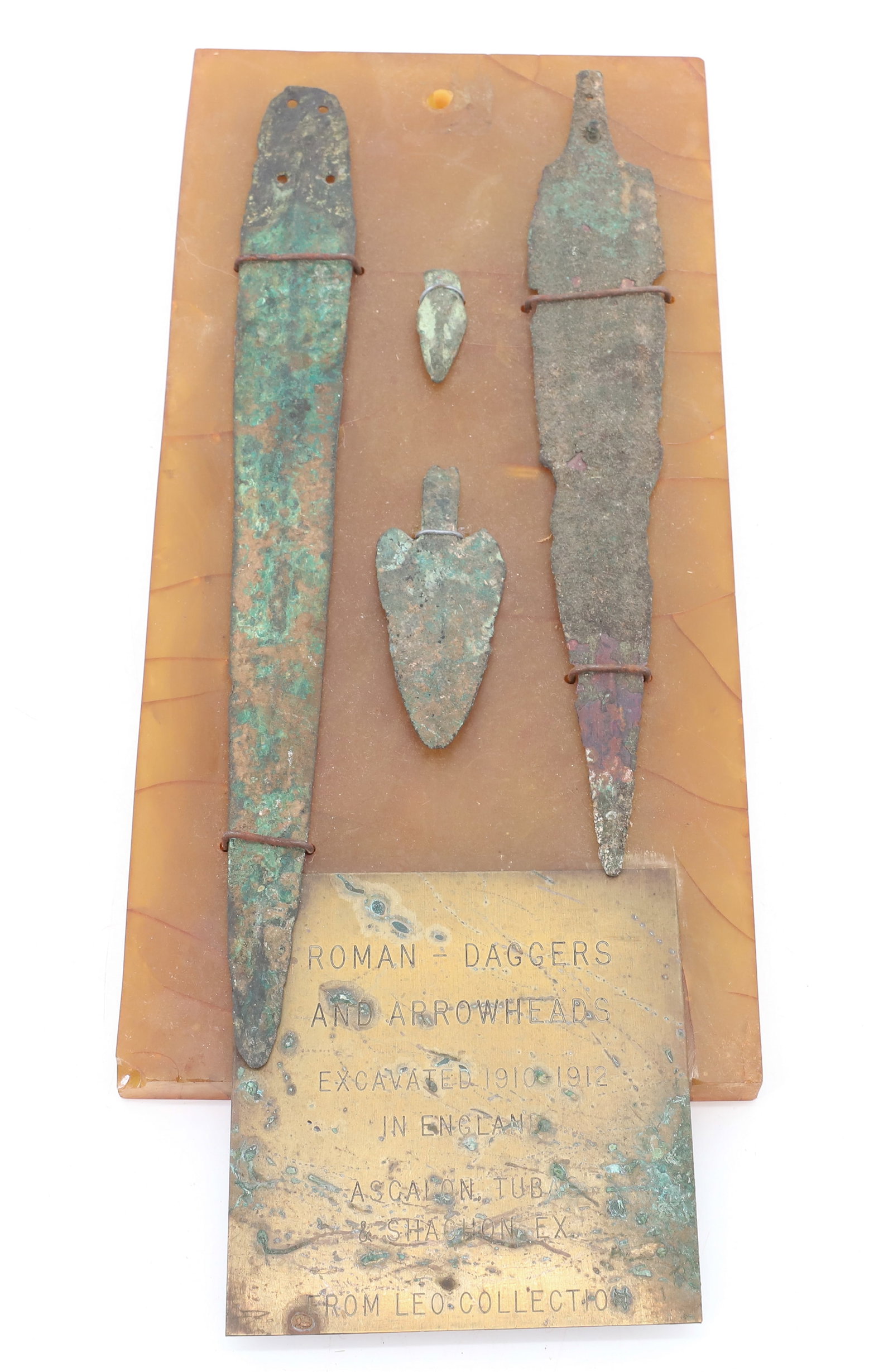 LOT OF BRONZE ARTIFACTS: MRKD "ROMAN-DAGGERS AND ARROWHEADS, EXCAVATED 1910-1912 IN ENGLAND, ASCALON TUBAS AND SACHON EX. FROM LEO COLLECTION". LARGEST 9 7/8" L. PLEASE READ CAREFULLY BEFORE BIDDING. ALL PAYMENTS MUST BE MADE
