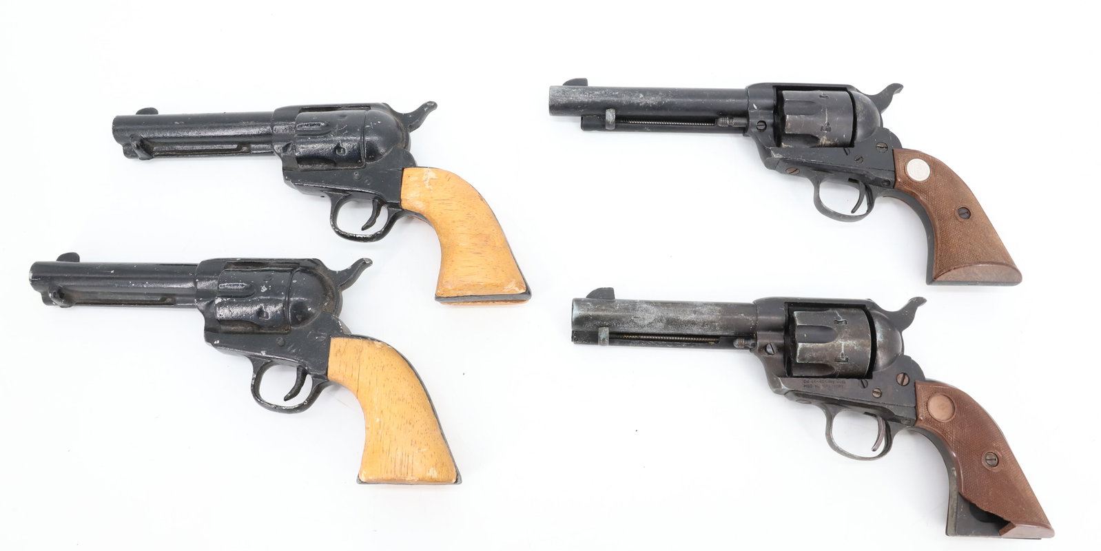 (2) PAIRS OF PROP REVOLVERS: PAIR WITH WOOD GRIPS 9" L. AND MOLDED GRIPS (MGO MANUFACTORY, 44-40 LONG BLANK) 10 1/4" L. PLEASE READ CAREFULLY BEFORE BIDDING. ALL PAYMENTS MUST BE MADE BEFORE ITEMS CAN BE SHIPPED. BUYERS CAN PAY V