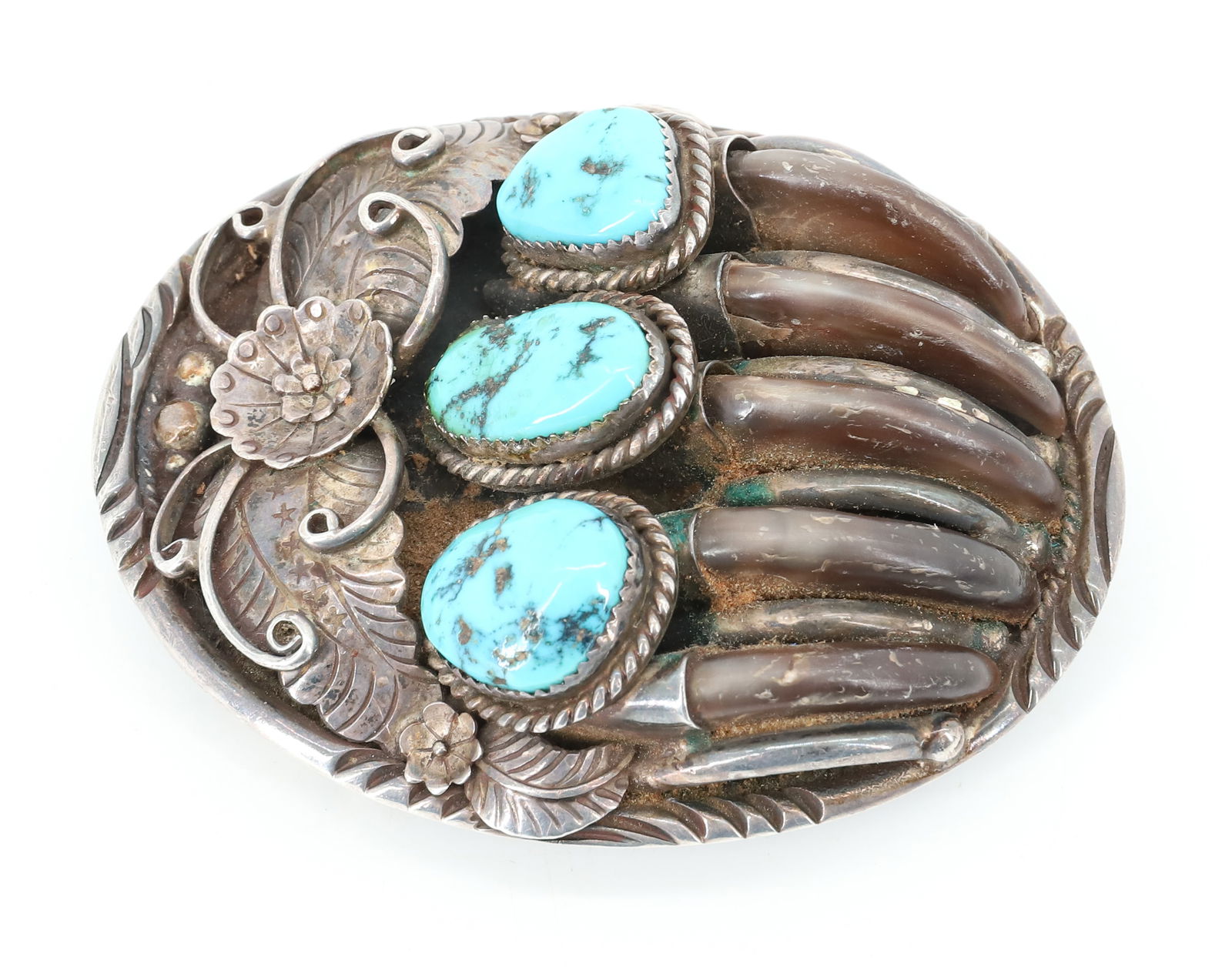 LARGE NATIVE AMERICAN BELT BUCKLE: STERLING SILVER AND TURQUOISE "BEAR CLAW" MOTIF BUCKLE. 3 1/4" X 2 1/2". MRKD. ON BACK WITH STAR AND "STERLING". PLEASE READ CAREFULLY BEFORE BIDDING. ALL PAYMENTS MUST BE MADE BEFORE ITEMS CAN BE SHI