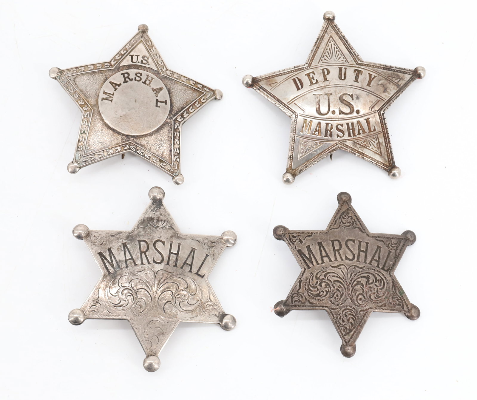 LOT OF MARSHAL BADGES: (4) INCLUDING: TWO FIVE-POINT STAR (US MARSHAL, DEPUTY US MARSHAL 2 5/8" AND 2 3/4") AND TWO SIX-POINT STAR (2 1/4" AND 2 3/4"). PLEASE READ CAREFULLY BEFORE BIDDING. ALL PAYMENTS MUST BE MADE BEFORE 