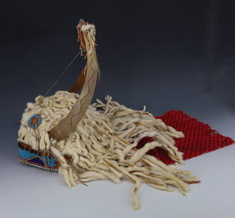 NATIVE AMERICAN ERMINE HEADDRESS: SPLIT HORNS WITH BEADWORK, FRINGE AND ERMINE. RED PRINTED FABRIC. 14" H. PLEASE READ CAREFULLY - Terms for Purchasing and Shipping of Auction Items. Please read carefully before bidding. All payments