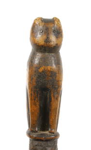 FOLK ART CARVED CAT CANE: SEATED CAT WITH NAILHEAD EYES ON WAVY, NOTCHED SHAFT. 29" L. PLEASE READ CAREFULLY - Terms for Purchasing and Shipping of Auction Items. Please read carefully before bidding. All payments for purchase