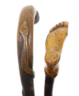 (2) FOLK ART CANES: ONE WITH CARVED FOOT HANDGRIP 34" L. WITH, CARVED SNAKE ON SHAFT MRKD. "USS SANTA ANNA". 25" L. PLEASE READ CAREFULLY - Terms for Purchasing and Shipping of Auction Items. Please read carefully before
