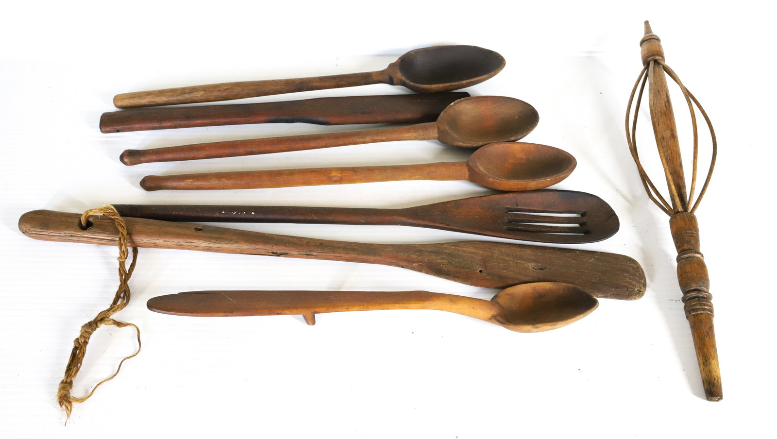 LOT OF WOODEN UTENSILS: VARIOUS ANTIQUE WOODEN SPOONS, STIRRERS, PADDLES AND MORE. LARGEST 20" L. PLEASE READ CAREFULLY â€“ THIS IS AN IN-PERSON & ON-LINE AUCTION. SALE IS LOCATED IN HARMONY TOWNSHIP, PHILLI