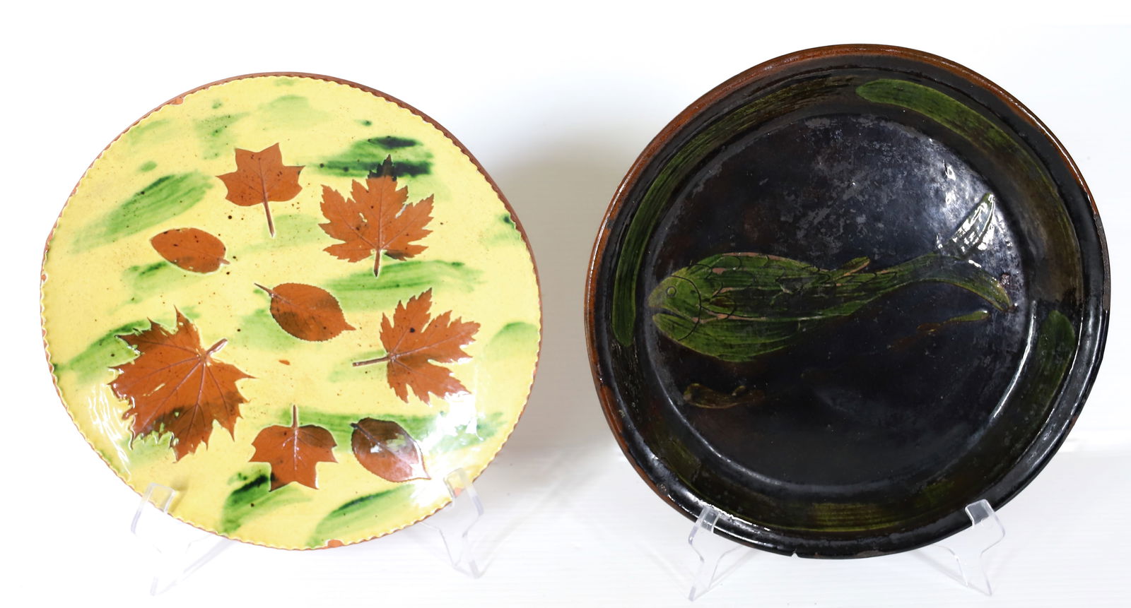 LESTER BREININGER REDWARE PLATE: YELLOW/GREEN GLAZE WITH LEAF MOTIFS. SGND. ON BACK "BREININGER, ROBESONIA, APRIL 26, 1980, NICE DAY". 10 1/2" D. WITH, DARK GLAZE PIE PLATE WITH GREEN FISH DECORATION 10 7/8" D. PLEASE READ CAREFULLY
