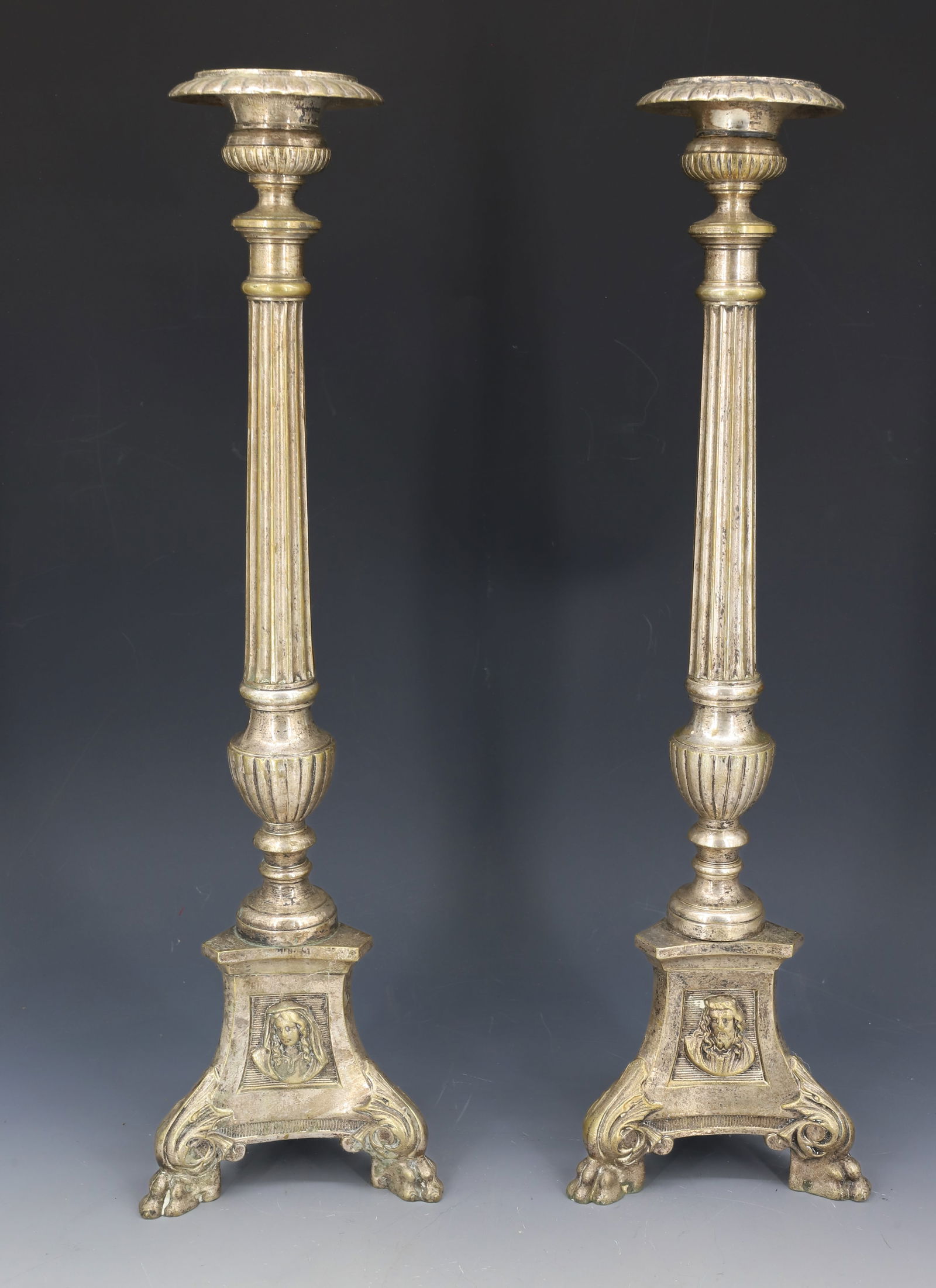 PAIR OF FRENCH CANDLESTICKS: ALTAR CANDLESTICKS WITH PAW FEET AND RELIGIOUS DEPICTIONS IN THREE PANELS. 17 1/4" H. PLEASE READ CAREFULLY â€“ THIS IS AN IN-PERSON & ON-LINE AUCTION. SALE IS LOCATED IN HARMONY TOWN