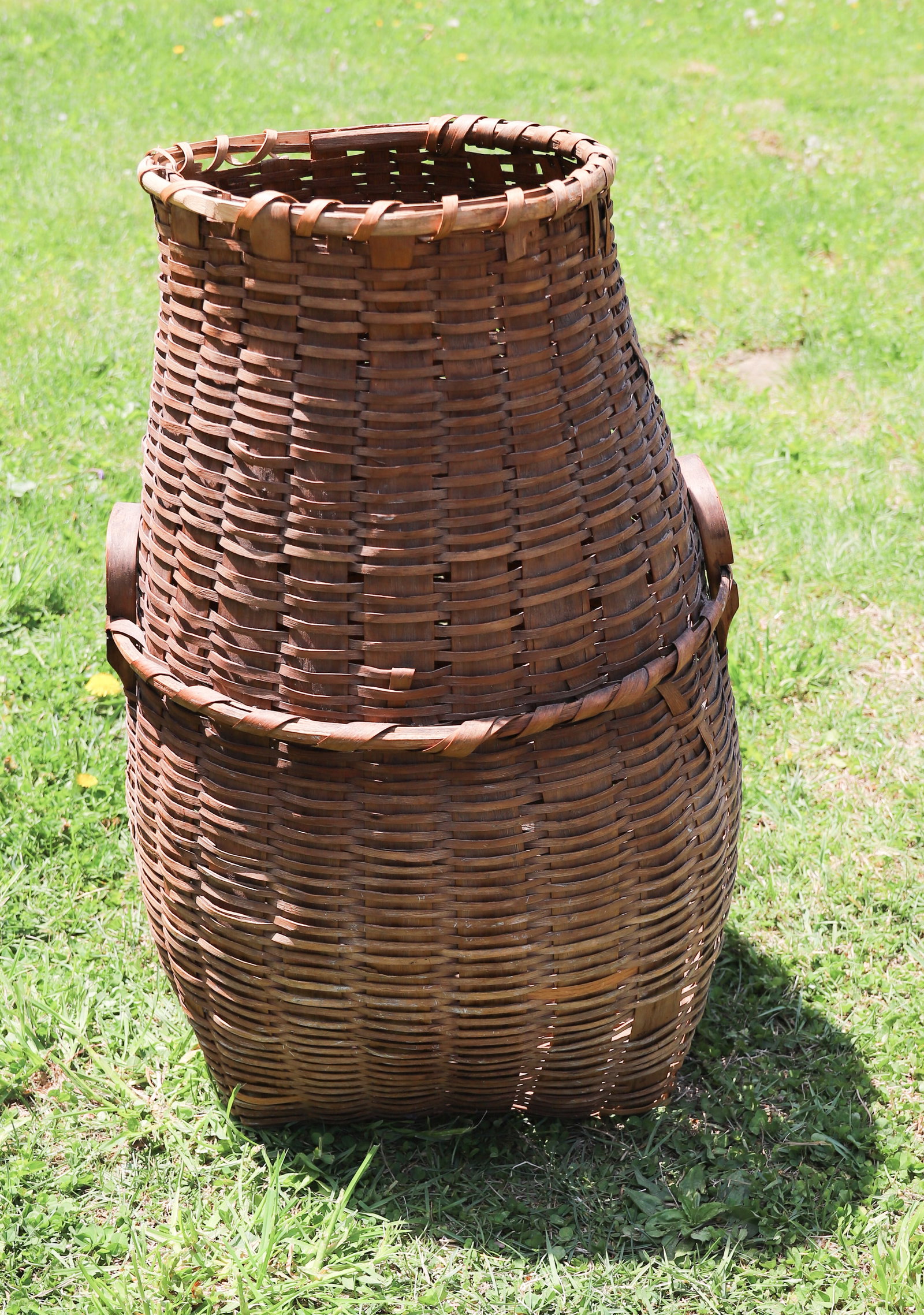 UNUSUAL SHAPED TALL BASKET: 2 WOVEN BASKET WITH WRAPPED SUPPORT AROUND MIDSECTION FOR BENTWOOD HANDLE ATTACHMENT 29 1/2" H. PLEASE READ CAREFULLY â€“ THIS IS AN IN-PERSON & ON-LINE AUCTION. SALE IS LOCATED IN HA
