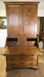 19TH C. TWO-PIECE SECRETARY DESK: WALNUT SECRETARY WITH TWO PANELED DOORS OVER SLANT/DROP FRONT WITH INTERIOR CUBBIES/DRAWERS/SECRET COMPARTMENTS. FOUR DOVETAILED GRADUATED DRAWERS WITH BRASS HARDWARE. REEDED COLUMNS. OGEE BRACKET FEE