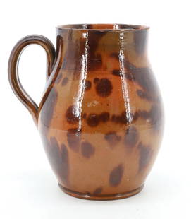 REDWARE POTTERY HANDLED CROCK: ORANGE/GREENISH GLAZE WITH BROWN SPLOTCHES. 7" X 4". PLEASE READ CAREFULLY - Terms for Purchasing and Shipping of Auction Items. Please read carefully before bidding. All payments for purchases will b