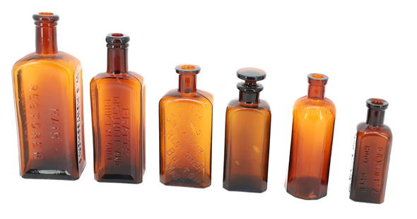 LOT OF AMBER ADVERTISING BOTTLES: INCLUDING: MONTGOMERY'S HAIR RESTORER 7 1/2" H., PRATT'S DISTEMPER AND PINK EYE CURE, FARR'S GRAY HAIR RESTORER (BOSTON), BOTTLE W/ STOPPER (MRKD. SD ON BOTTOM) 5 1/2" H., KENDALL'S SPAVIN CURE AND BR