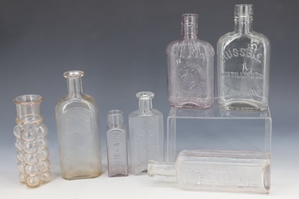 LOT OF CLEAR EMBOSSED BOTTLES
