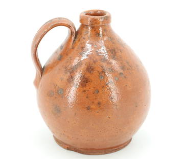 REDWARE OVOID JUG: ORANGE GLAZE WITH BROWN SPOTTING. 6 1/2" H. PLEASE READ CAREFULLY - Terms for Purchasing and Shipping of Auction Items. Please read carefully before bidding. All payments for purchases will be made th