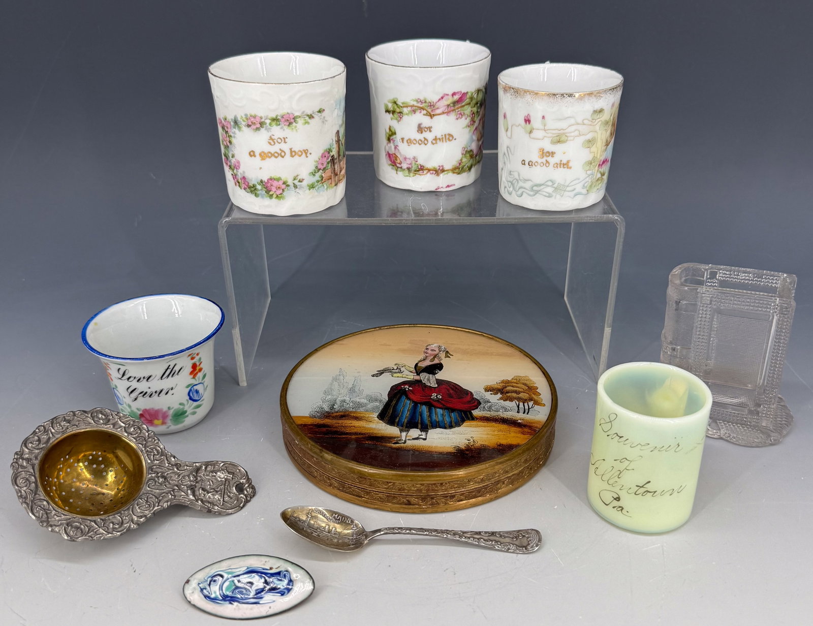 LOT OF VINTAGE SMALLS: INCLUDING: "FOR A GOOD GIRL/BOY" MUGS, SOUVENIR OF ALLENTOWN MUG, TEA STRAINER (GERMANY), SOUVENIR SPOON (BATTLESHIP MAINE), ROUND BOX WITH GLASS TOP (PAINTED FIGURE OF WOMAN WITH BIRD) 5 1/2" D. PLEA