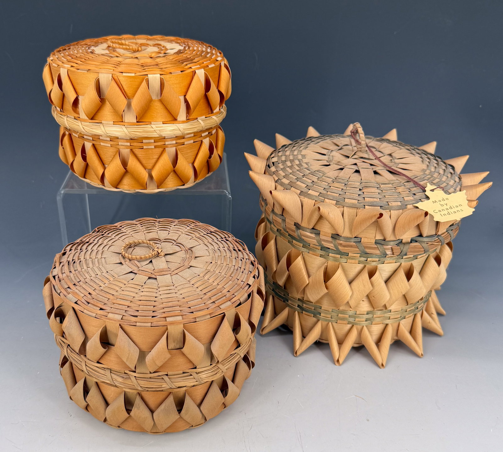 LOT OF NATIVE AMERICAN TOURIST BASKETS: THREE BASKETS WITH WOVEN DESIGNS. ONE WITH ORIGINAL TAG "MADE BY CANADIAN INDIANS". TALLEST 6 1/2" H. PLEASE READ CAREFULLY - Terms for Purchasing and Shipping of Auction Items. Please read carefully 