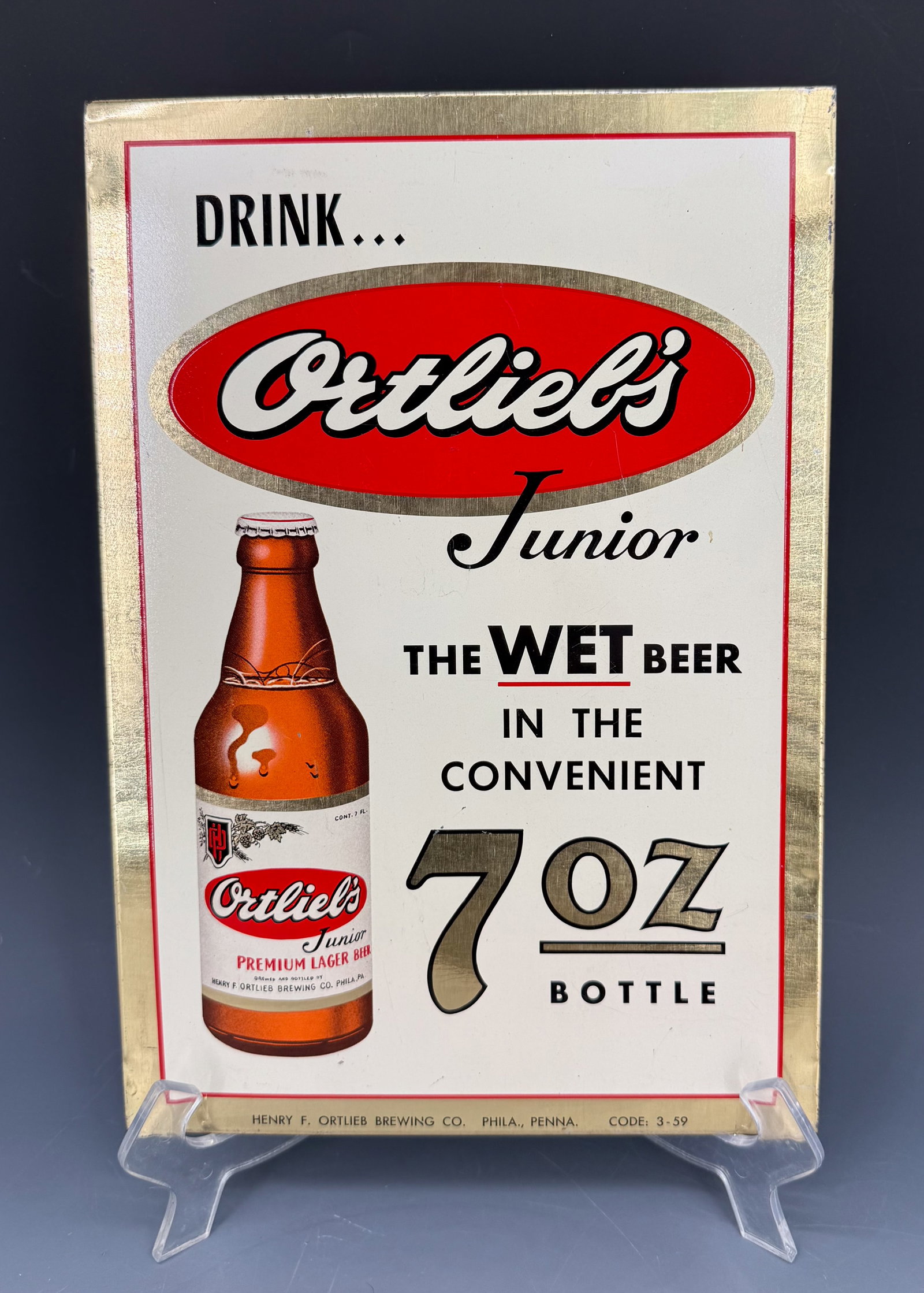 VINTAGE ORTLIEB'S BEER ADVERTISER: TIN "DRINK ORTLIEB'S JUNIOR, THE WET BEER IN THE CONVENIENT 7 OZ. BOTTLE". MRKD. 3-59. 12 3/4" X 9". PLEASE READ CAREFULLY - Terms for Purchasing and Shipping of Auction Items. Please read carefully b