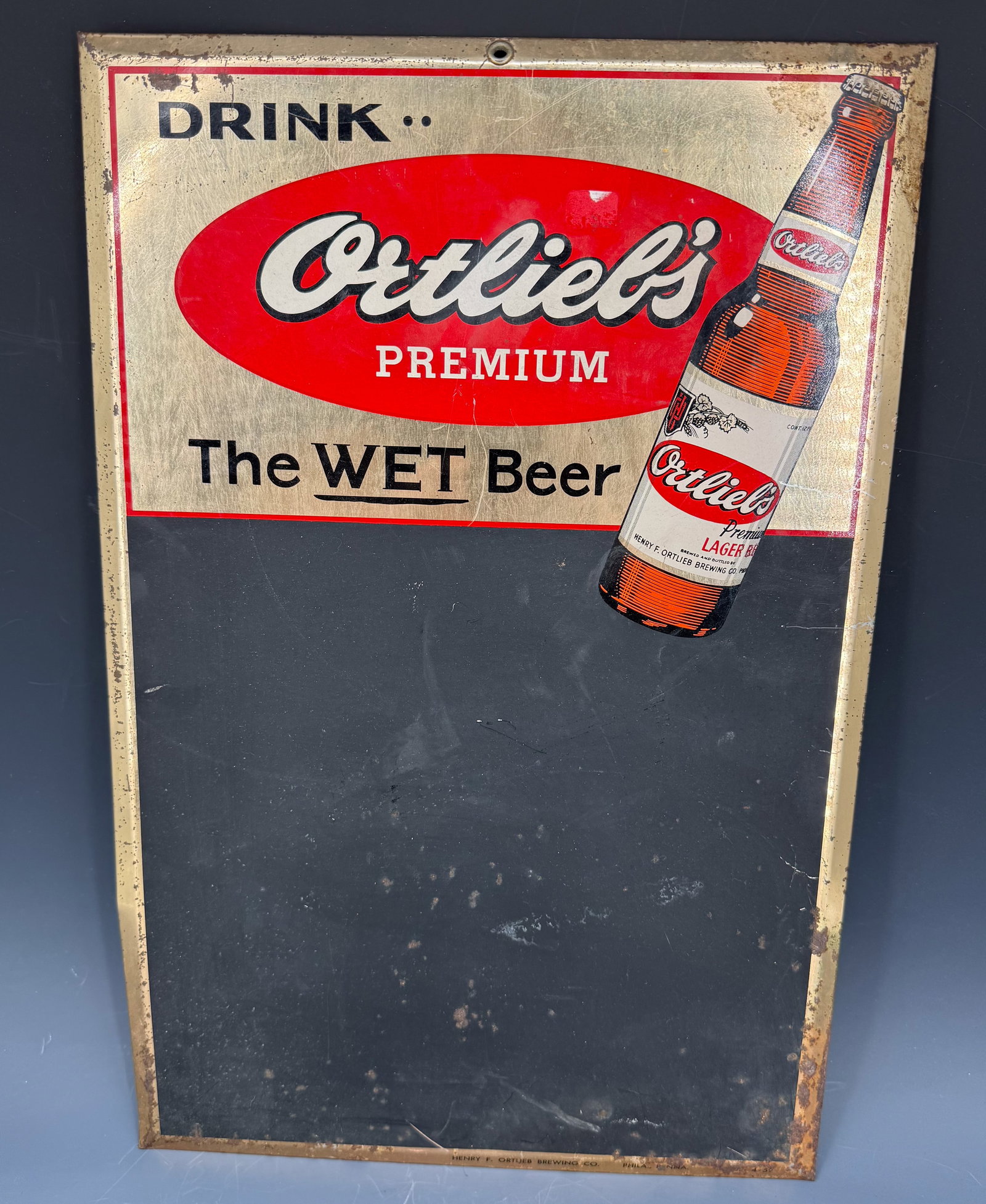 ORTLIEB'S PREMIUM BEER ADVERTISING CHALKBOARD: DRINK ORTLIEB'S PREMIUM, THE WET BEER. MRKD. 4-59. 19" X 12 1/2". PLEASE READ CAREFULLY - Terms for Purchasing and Shipping of Auction Items. Please read carefully before bidding. Hartzell’s Auc