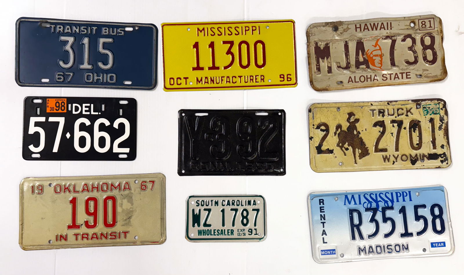 LOT OF VINTAGE LICENSE PLATES: VARIETY INCLUDING: PORCELAIN DELAWARE, OHIO TRANSIT 1967, OKLAHOMA TRANSIT 1967, MISSISSIPPI MANUFACTURER 1996, CONNECTICUT 1930 AND MORE. LARGEST 12" L. PLEASE READ CAREFULLY - Terms for Purchasing a