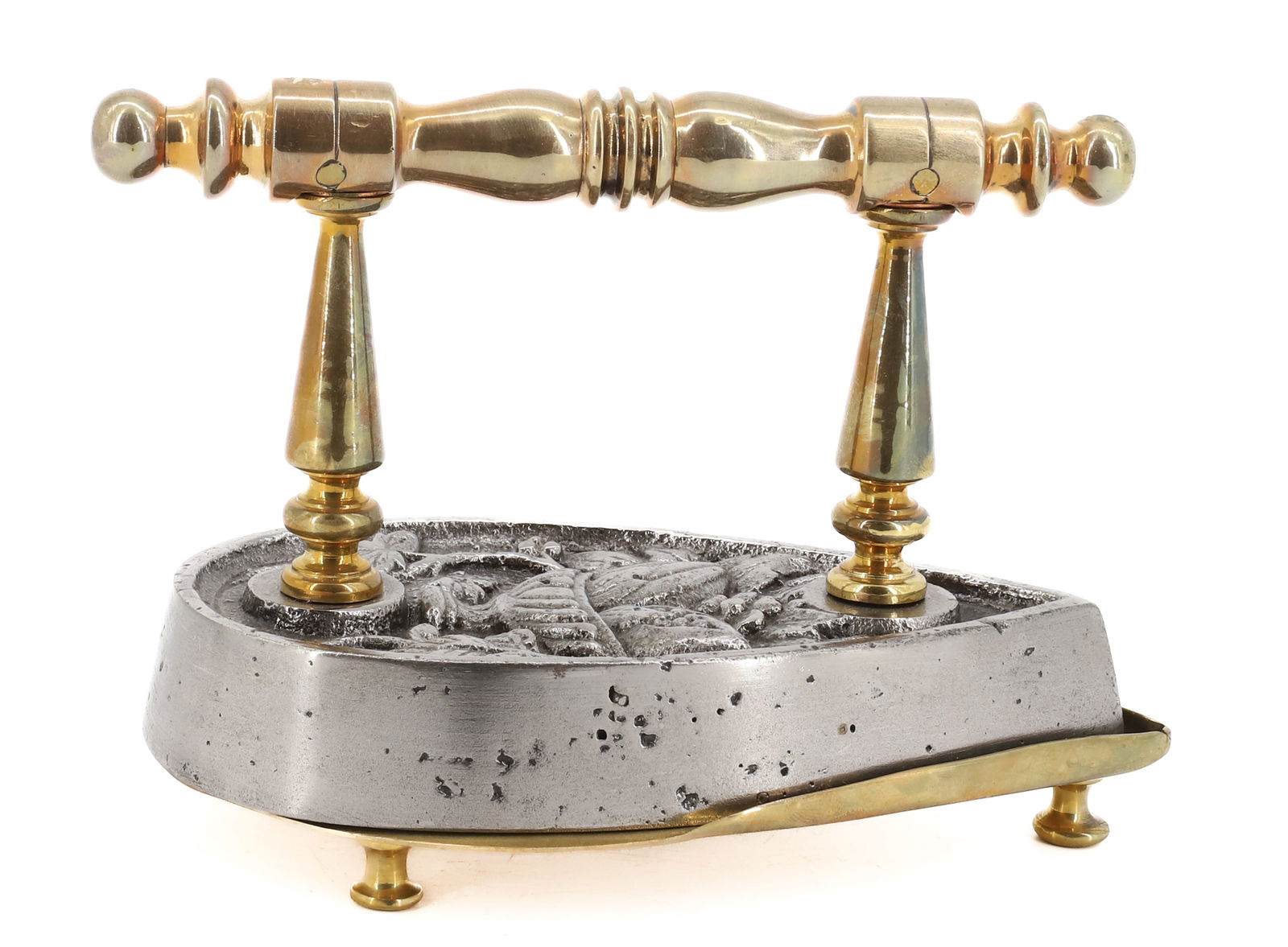 BELGIAN TEARDROP FLAT IRON: TEARDROP SHAPE WITH URN, VINES, MELON DESIGN. BRASS TURNED POSTS AND TRIVET. FANCY OVERALL DESIGN WITH FINE DECORATION. 7" L. PLEASE READ CAREFULLY - Terms for Purchasing and Shipping of Auction Items